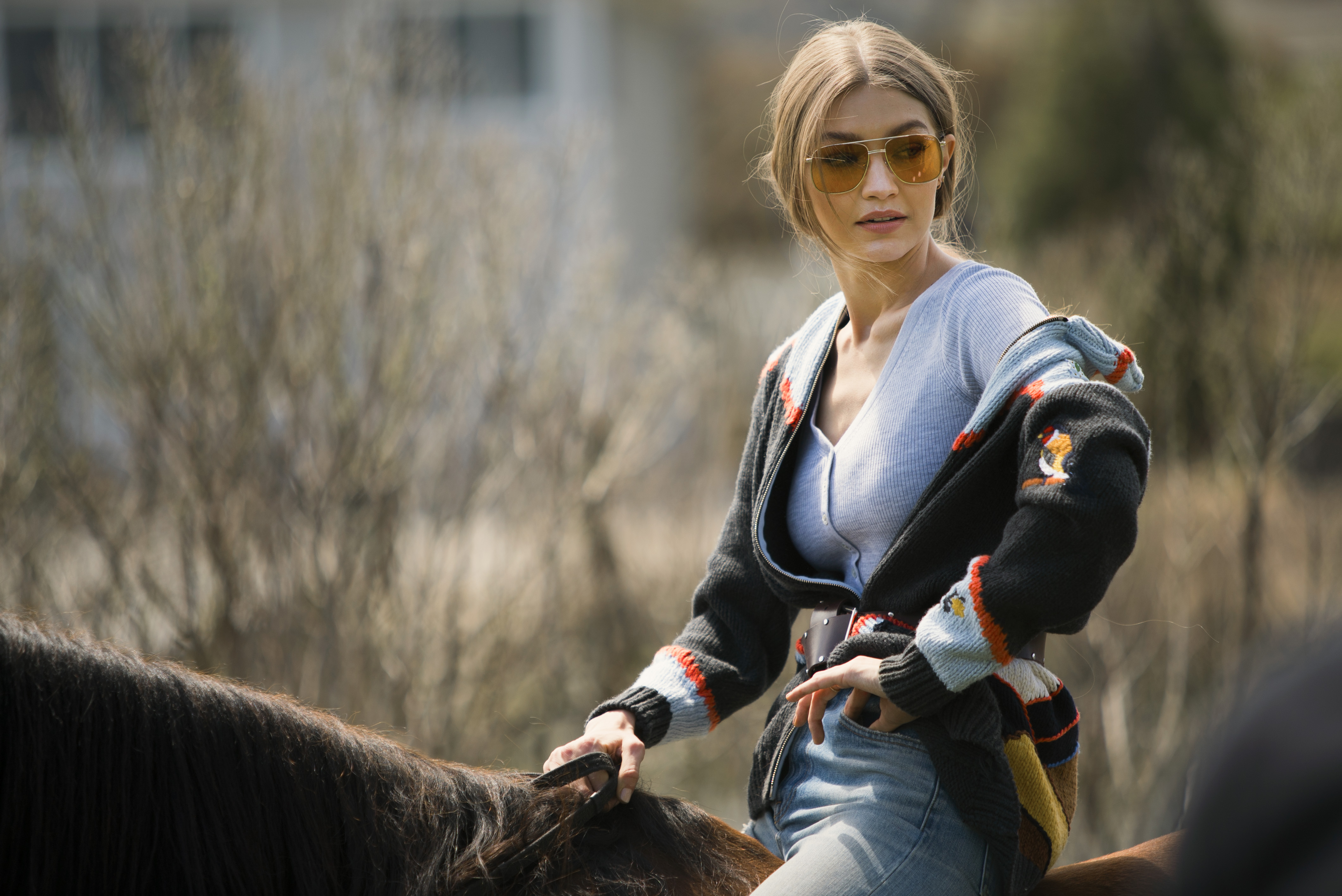 Gigi Hadid on a horse wearing sunglasses HD Wallpaper