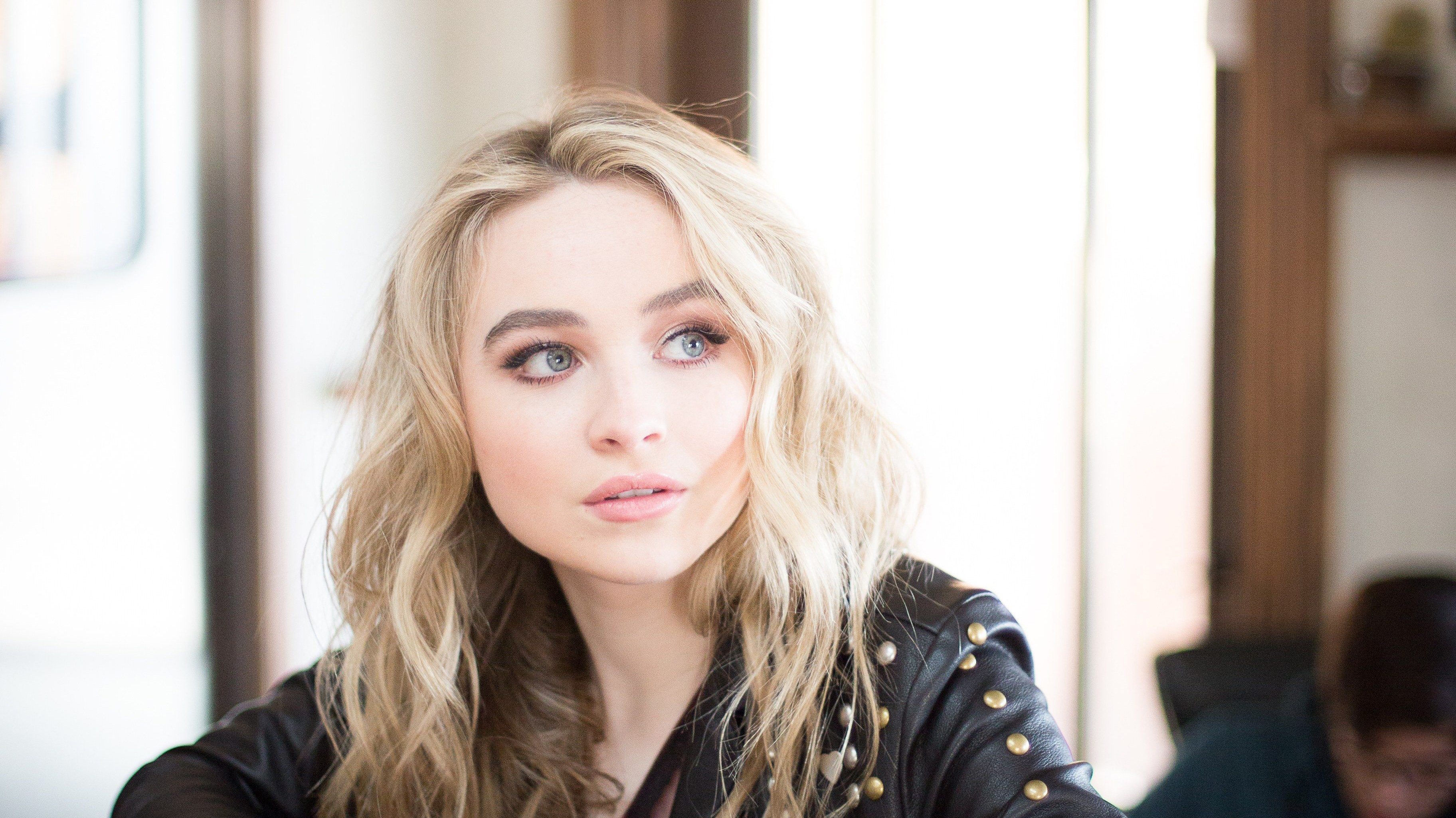 Sabrina Carpenter in a black leather jacket HD Wallpaper
