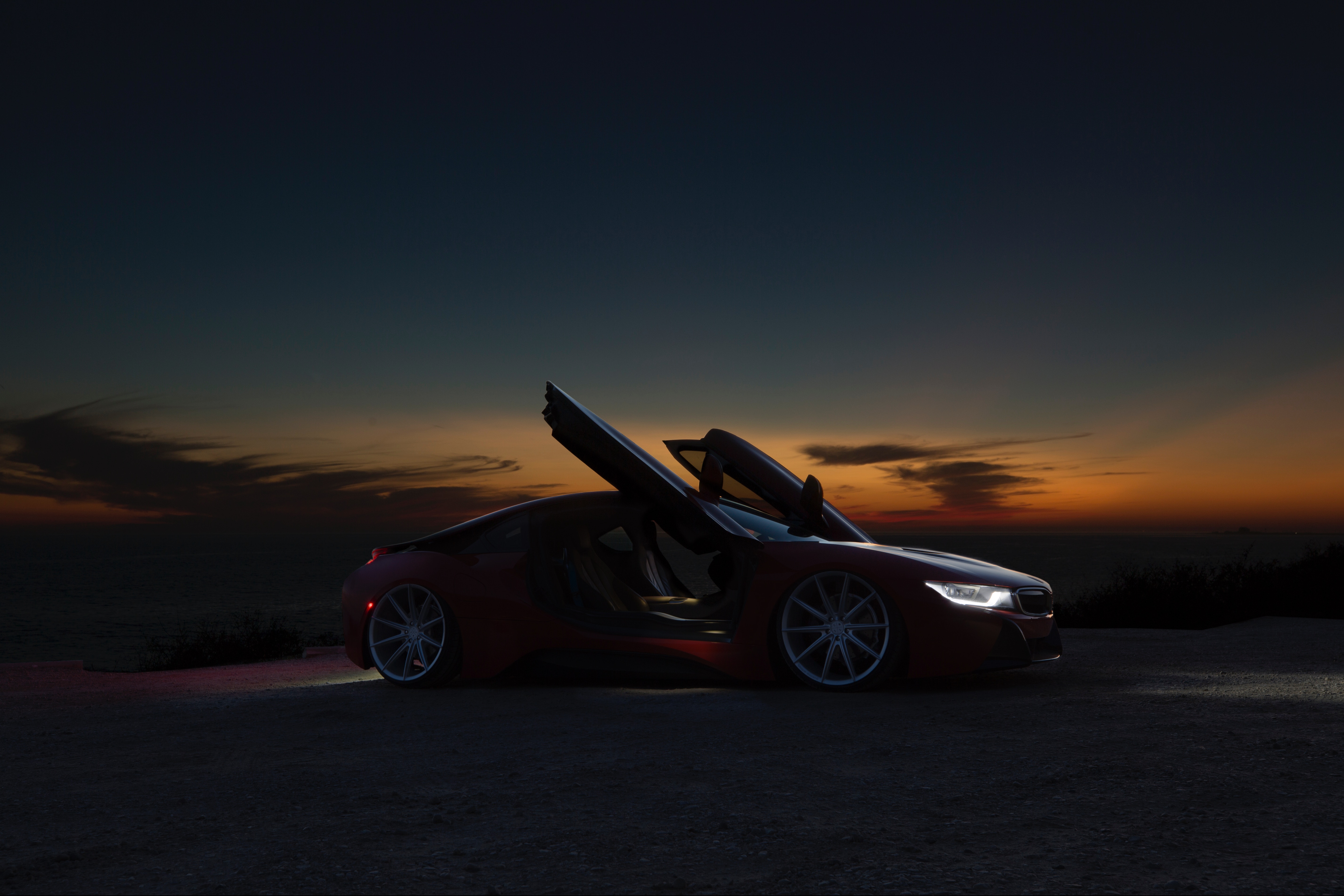 Red BMW i8 with butterfly doors at sunset HD Wallpaper