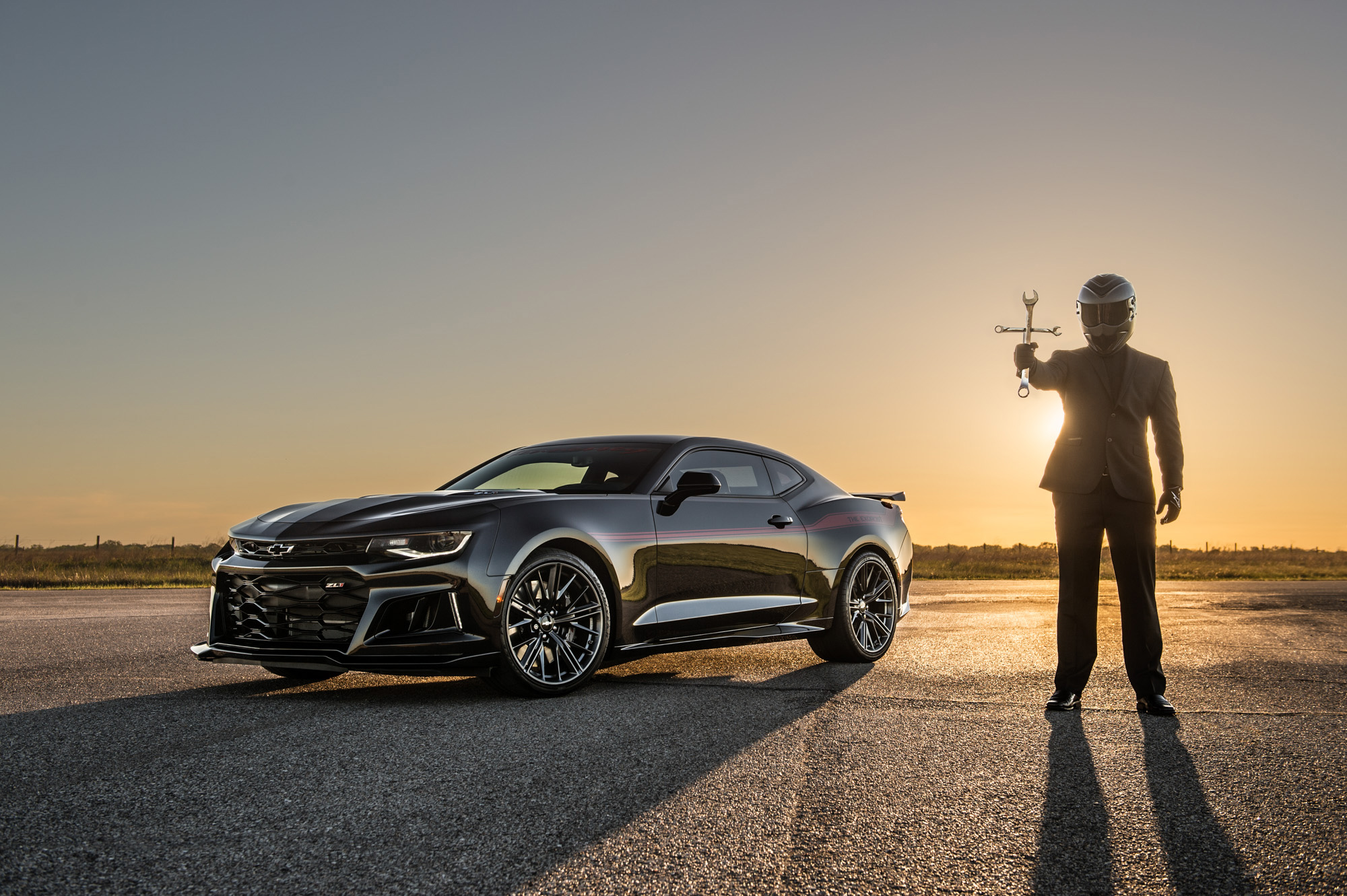 Chevrolet Camaro with a person in a suit and helmet HD Wallpaper