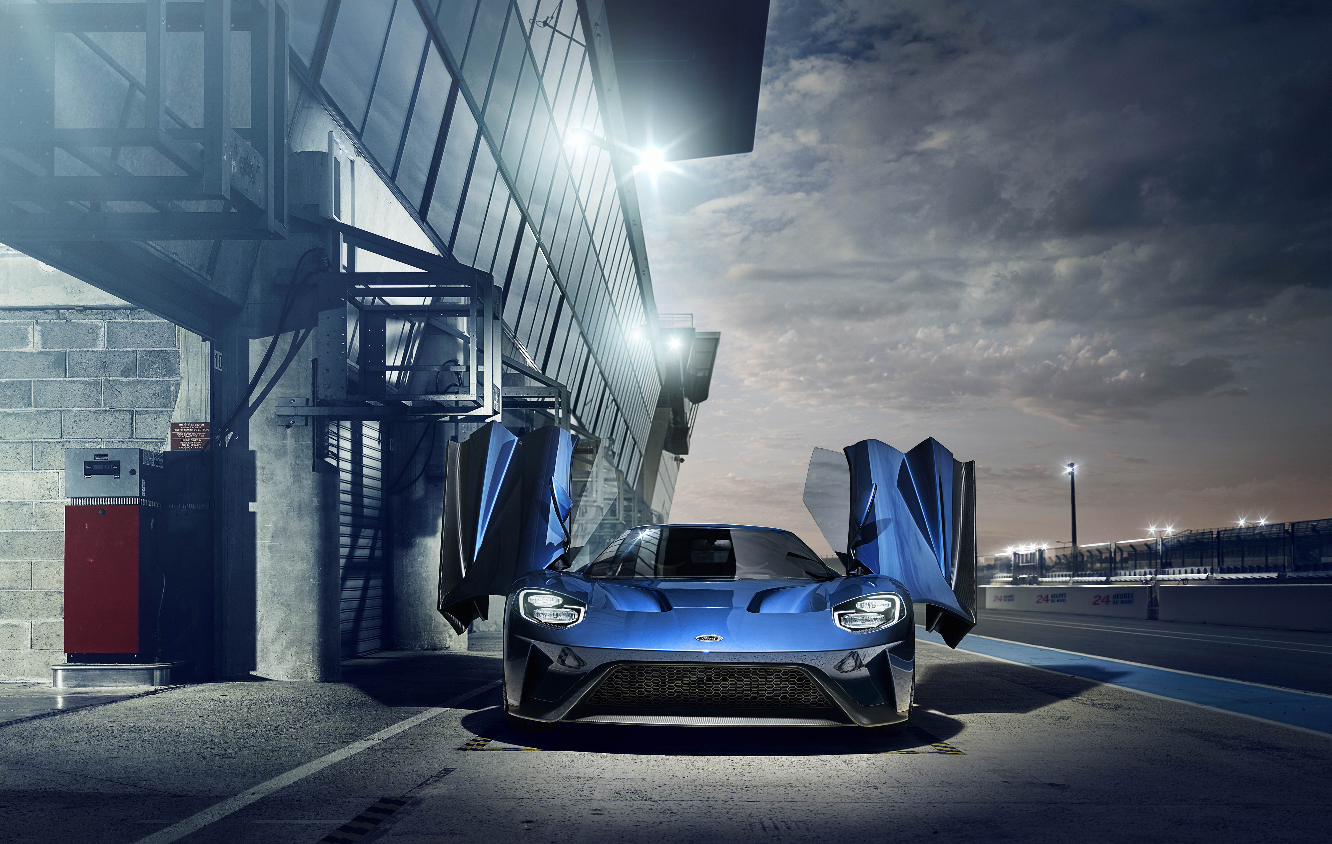 Blue Ford GT with doors open on a racetrack HD Wallpaper
