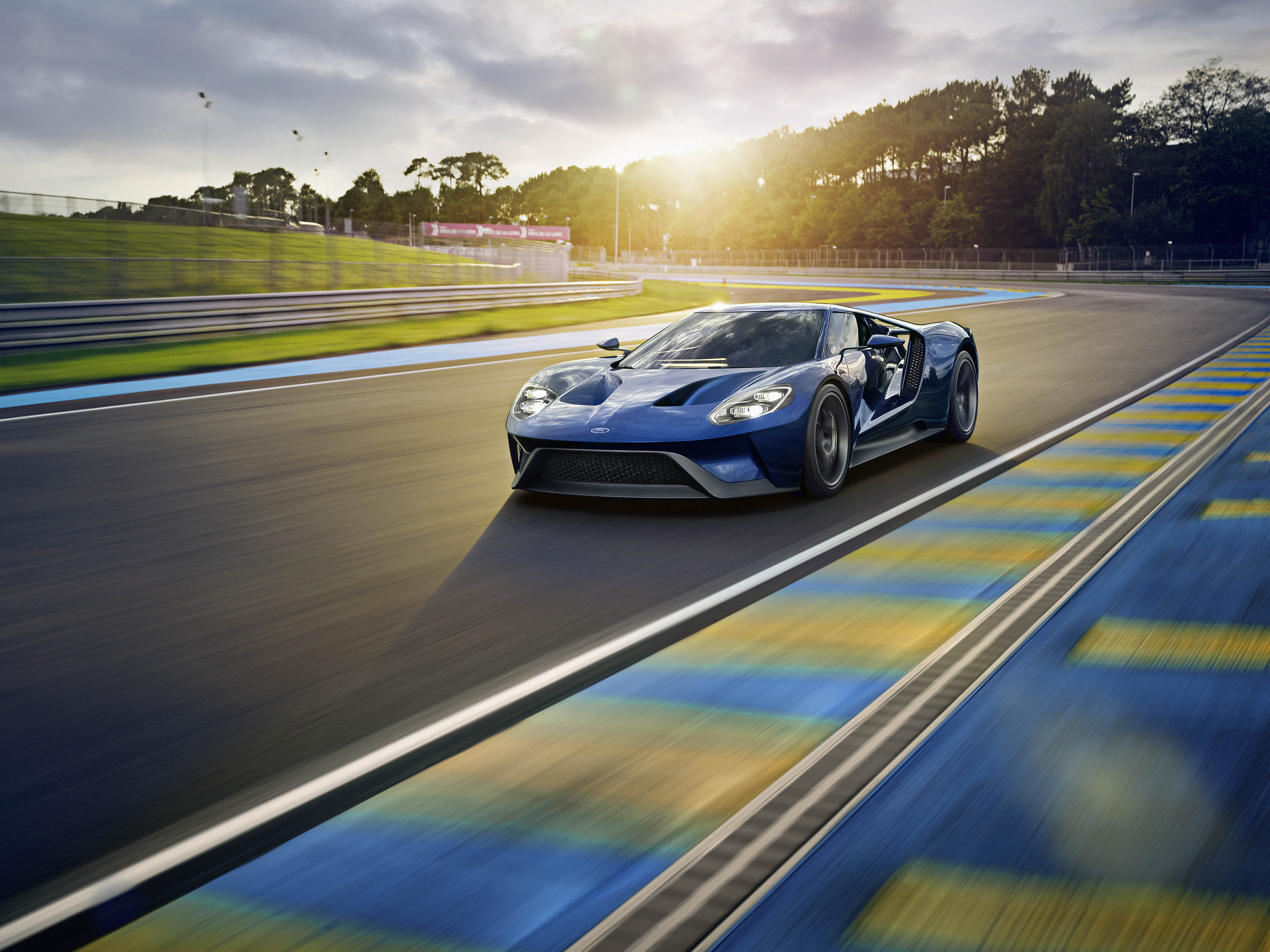 Blue Ford GT racing on a track HD Wallpaper