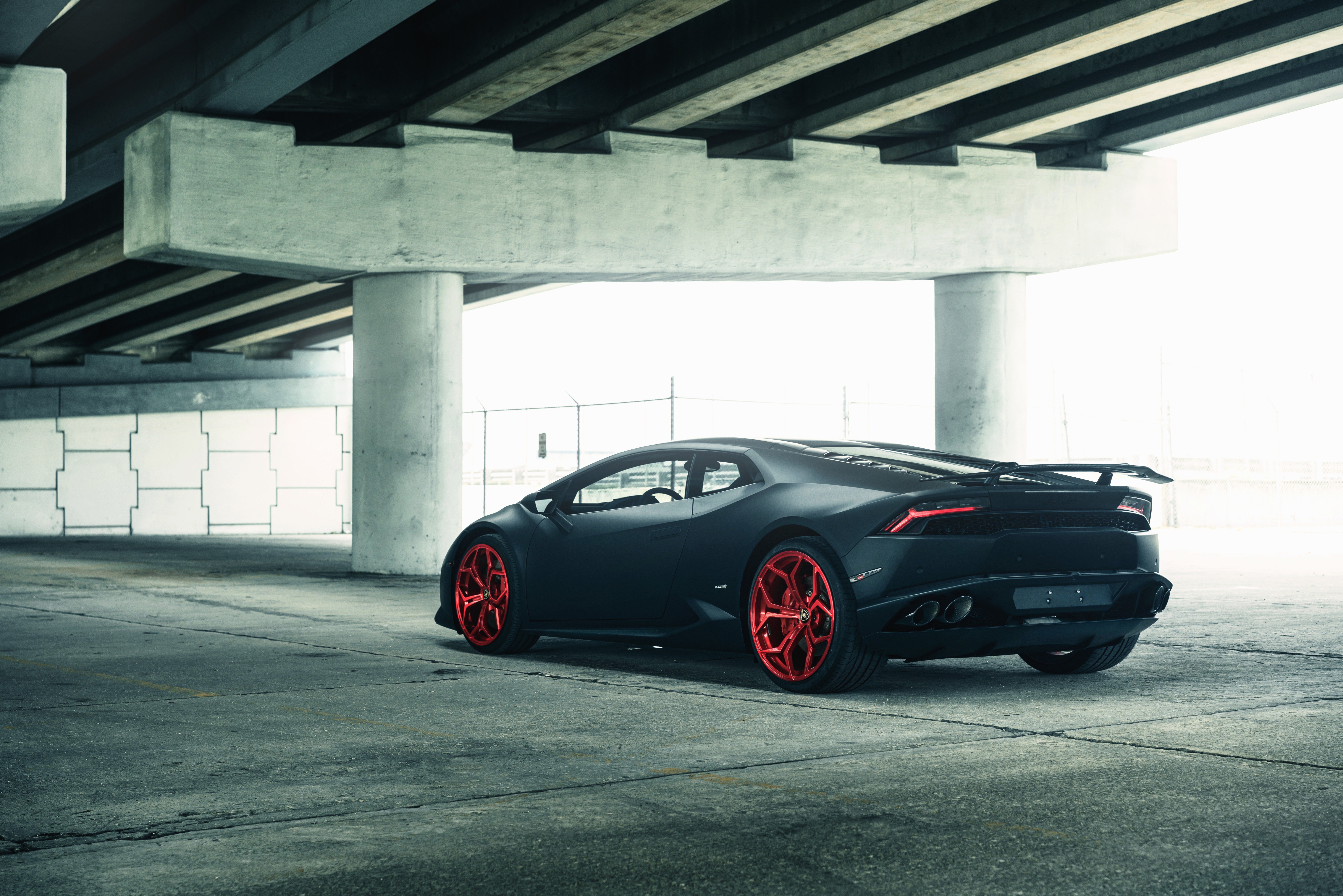 Matte black Lamborghini Huracan with red wheels HD Wallpaper