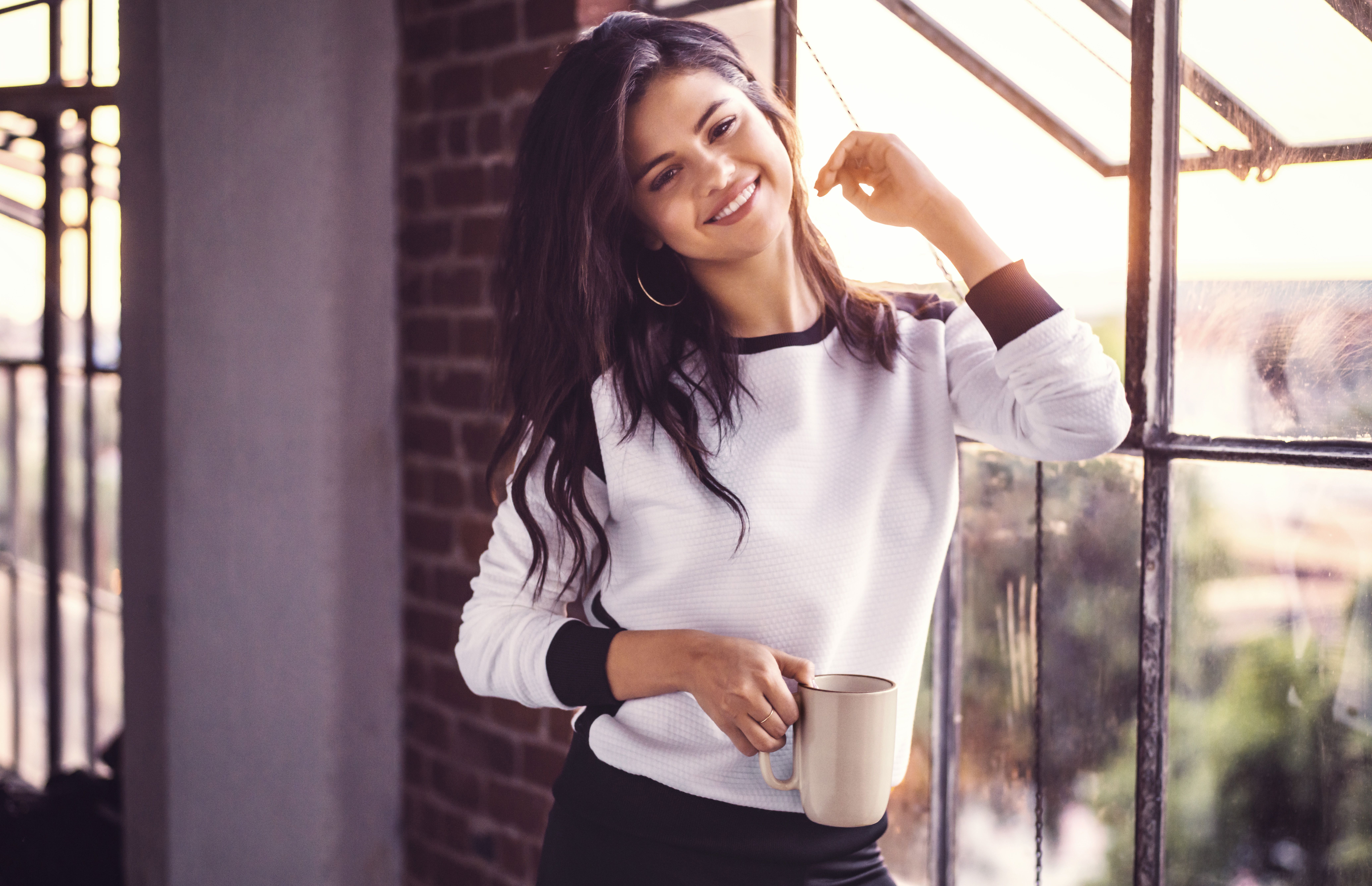 Selena Gomez holding a mug by the window HD Wallpaper