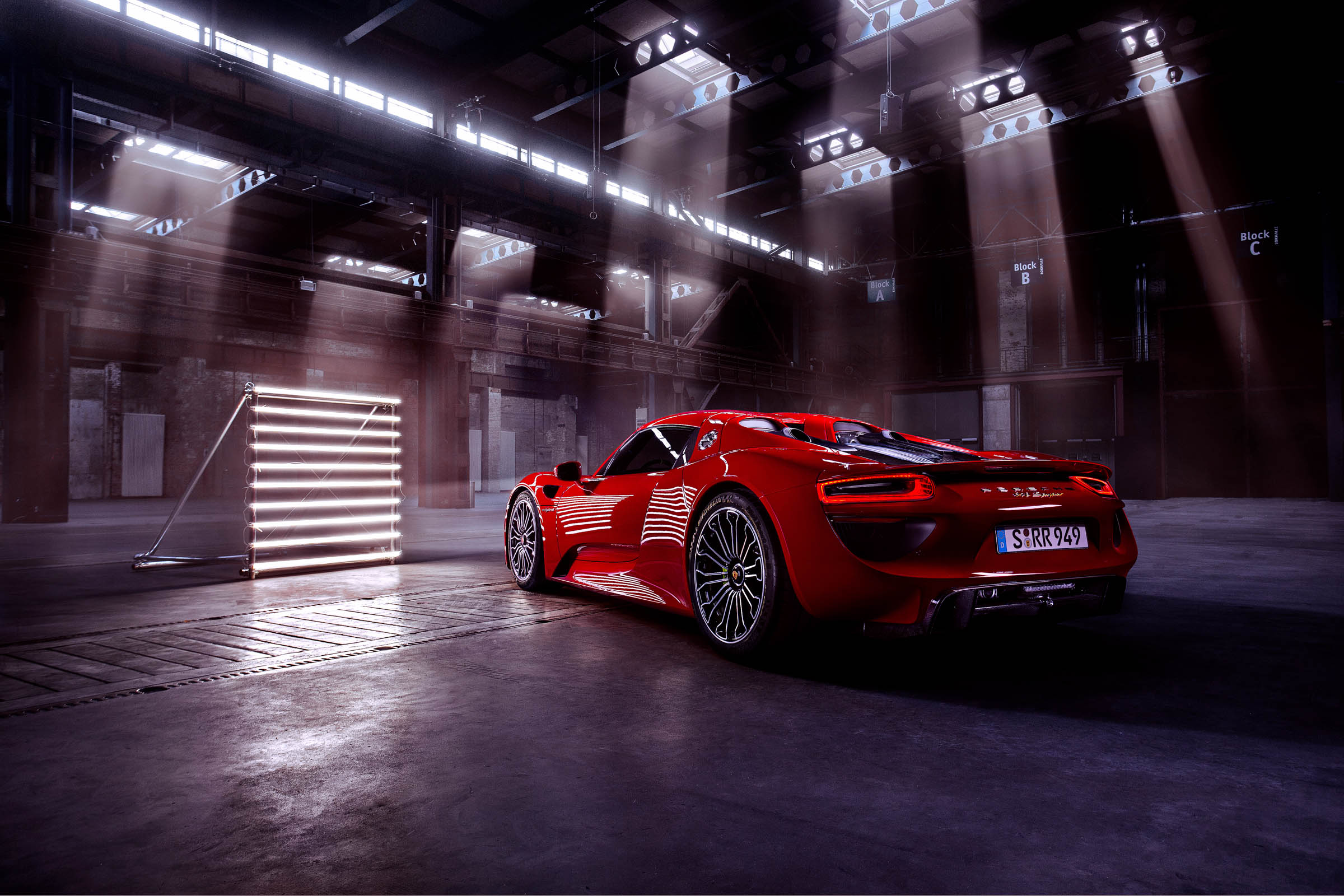 Red Porsche 918 in a studio with lights HD Wallpaper