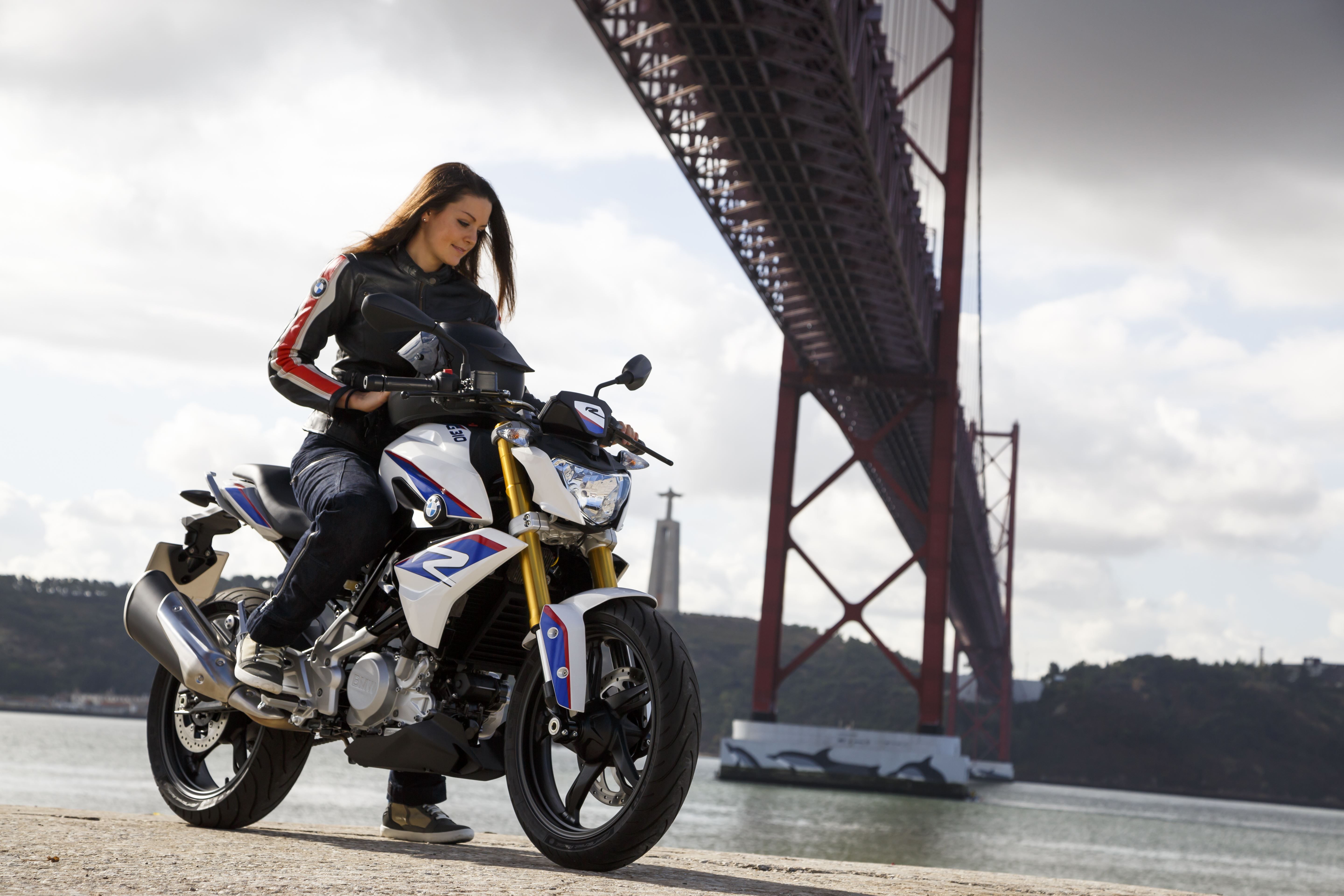 Woman on a BMW G310 R motorcycle under a bridge HD Wallpaper