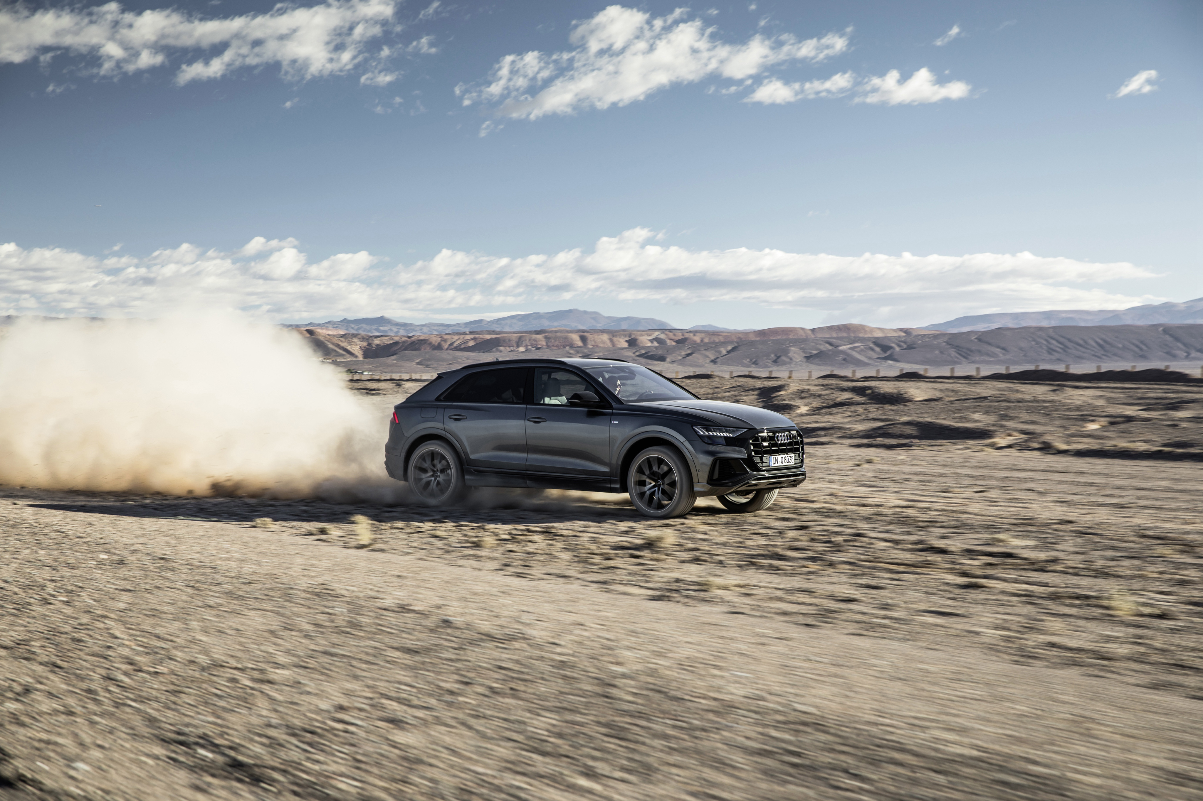 Audi Q8 driving on a dirt road HD Wallpaper