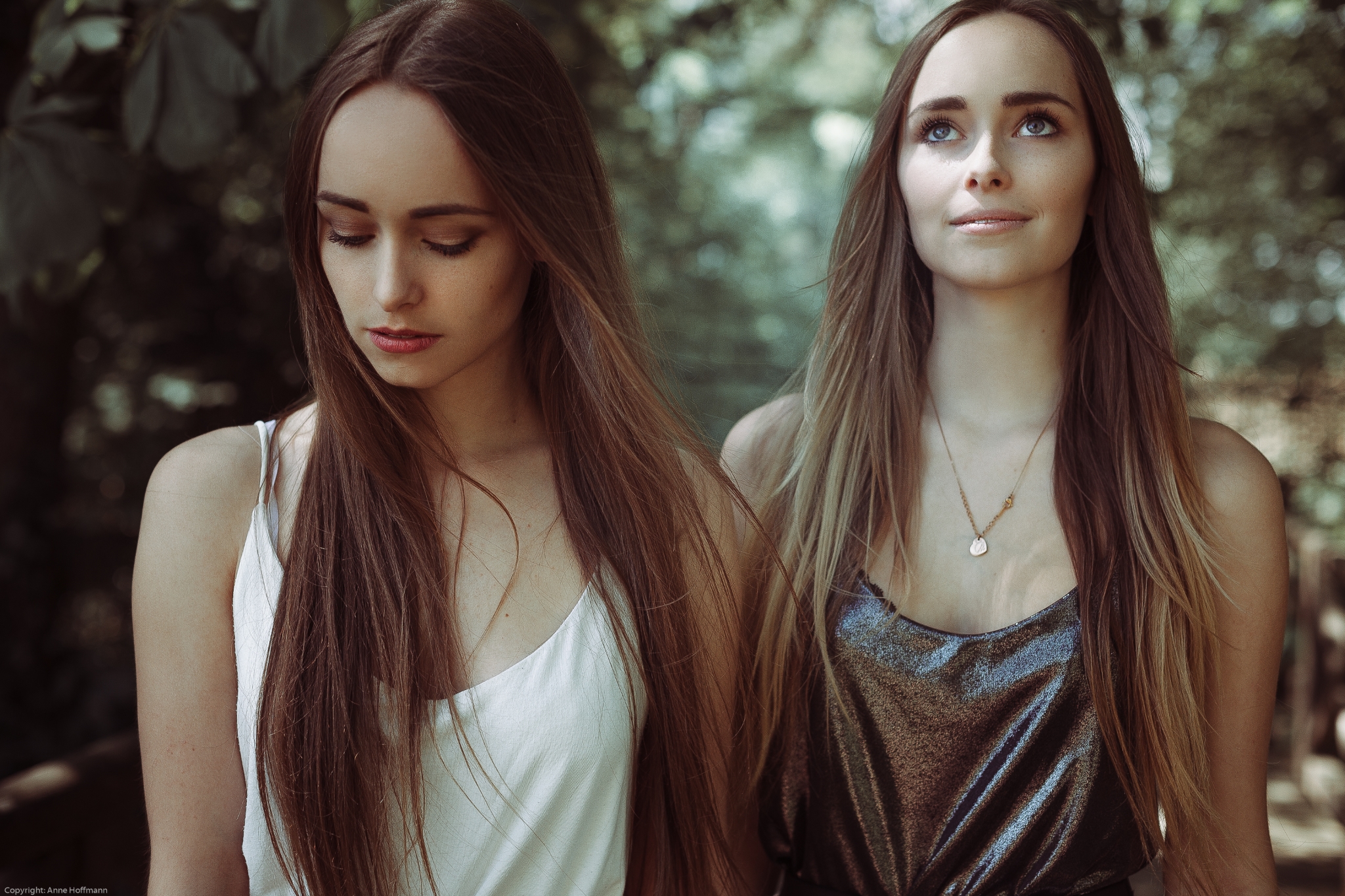 Two young women with long brown hair outdoors HD Wallpaper