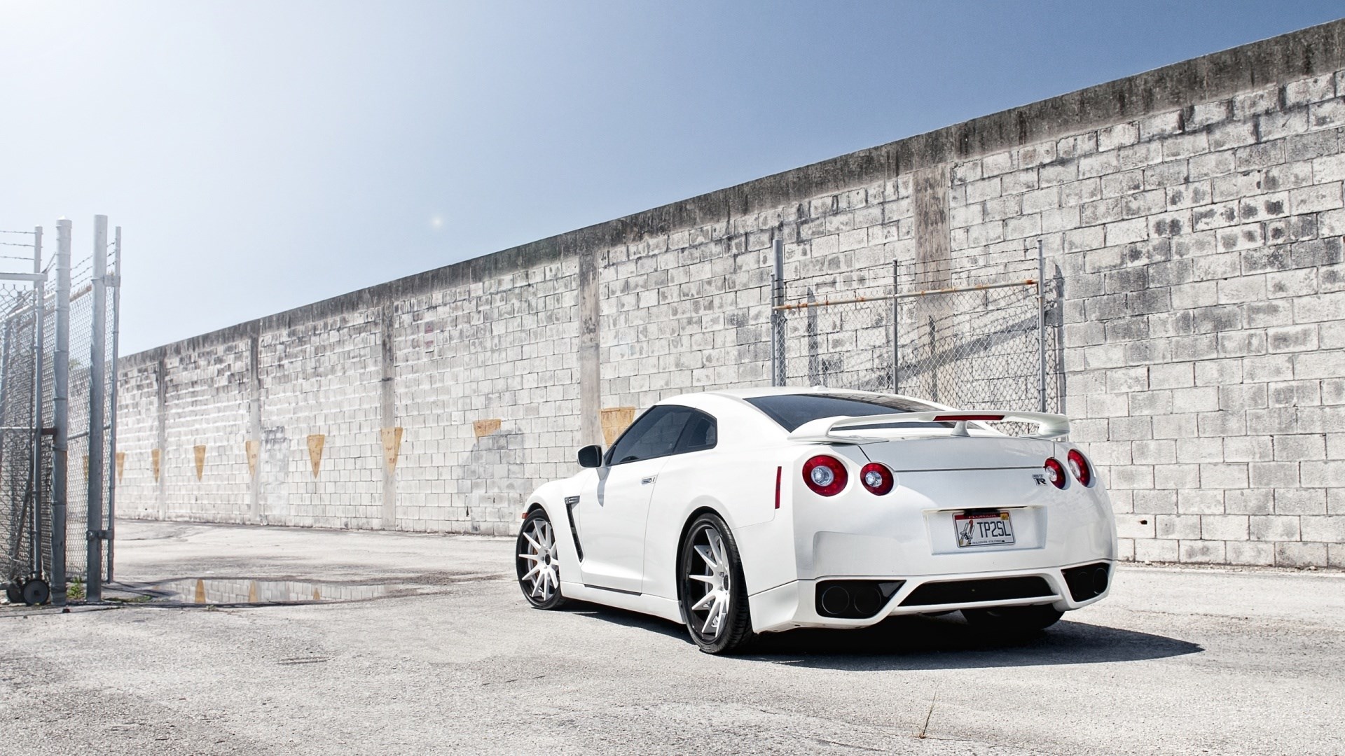 White Nissan GT-R parked near a brick wall HD Wallpaper