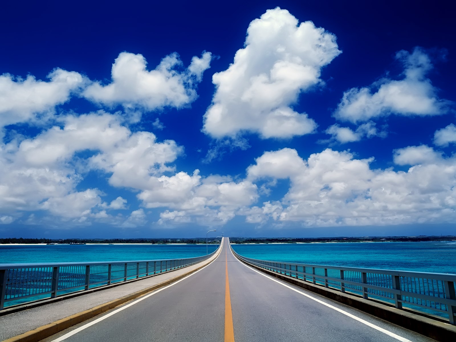 Bridge over turquoise water under blue sky with clouds HD Wallpaper