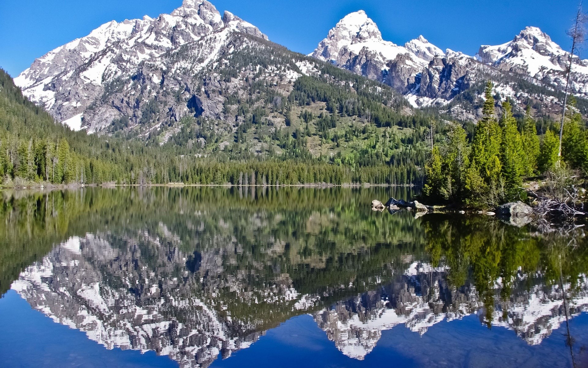 Snow-capped mountains reflected in a lake HD Wallpaper