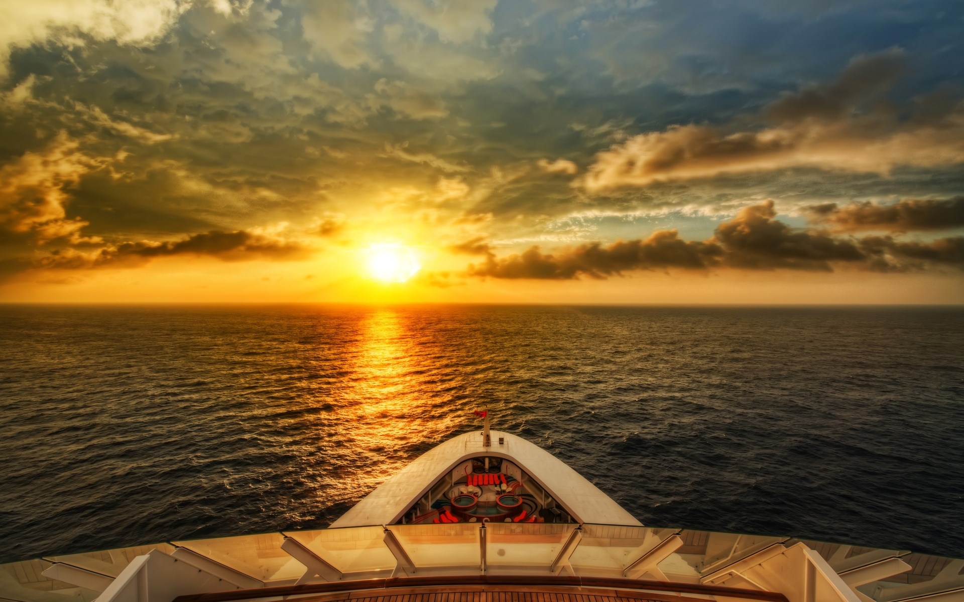 Sunset over the ocean from a cruise ship deck HD Wallpaper
