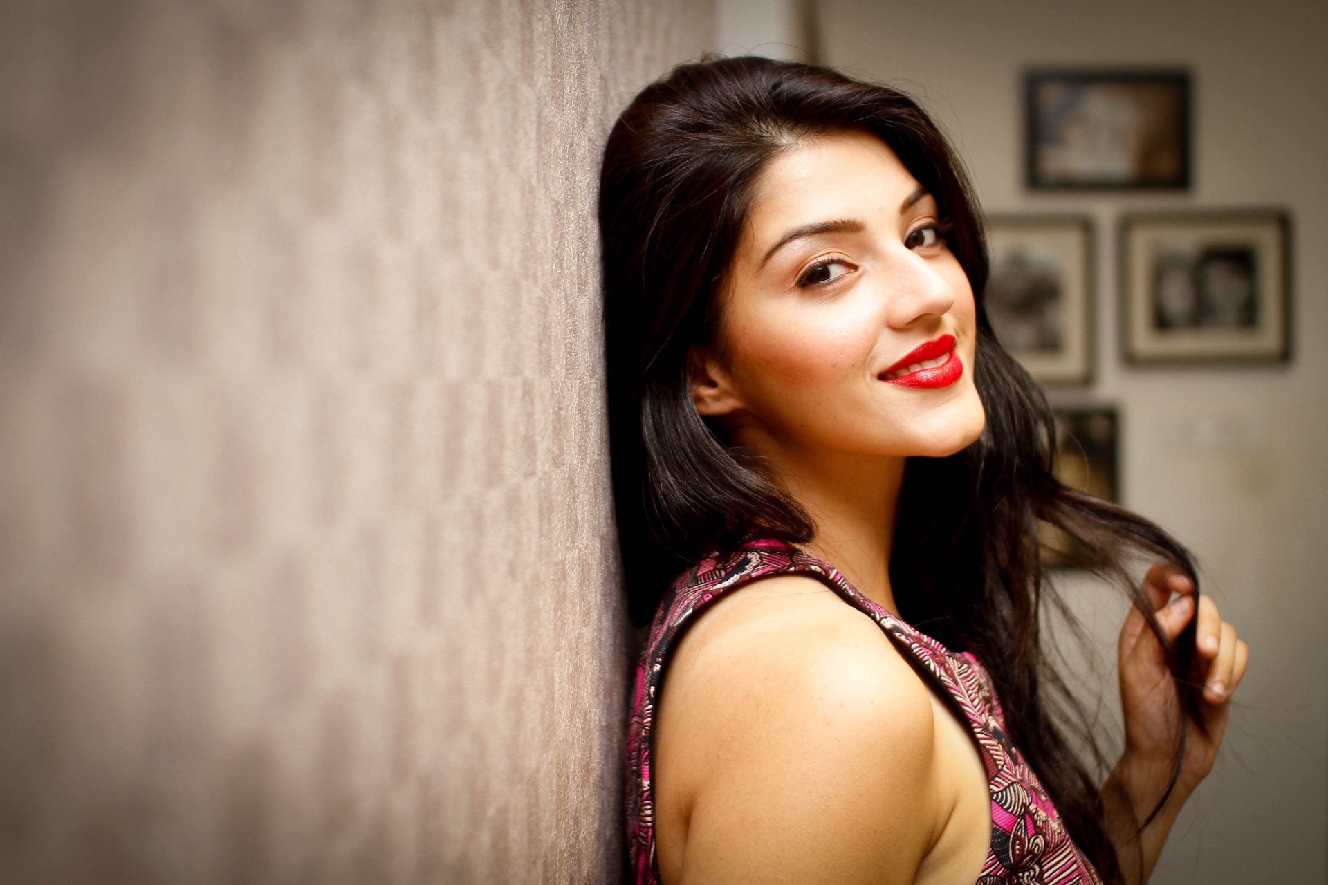 Mehreen Pirzada leaning against a textured wall HD Wallpaper