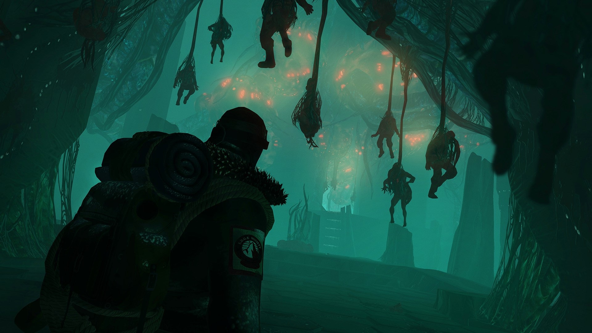 Man in Edge of Nowhere looking at hanging figures HD Wallpaper