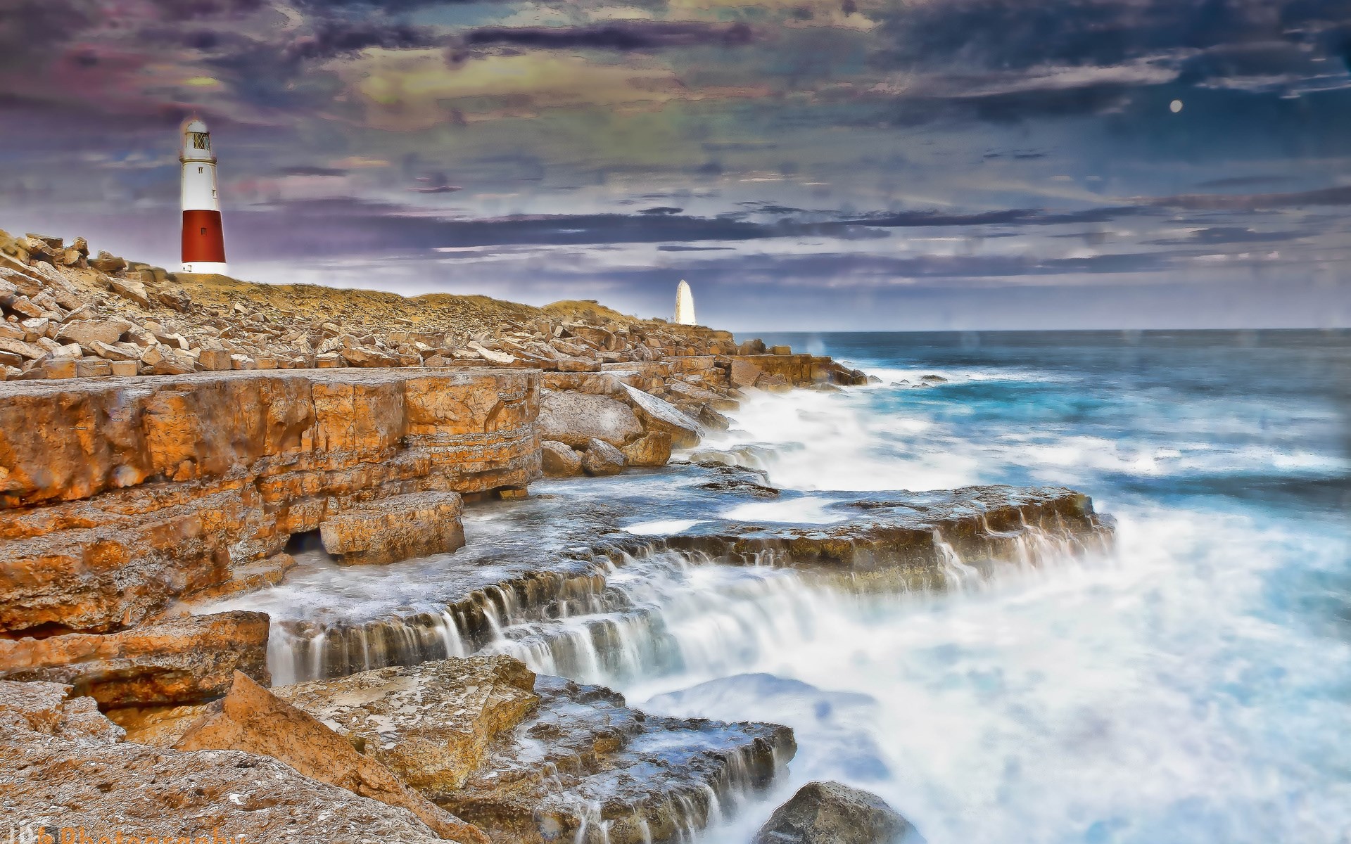 Portland Bill Lighthouse on rocky coast with waves HD Wallpaper