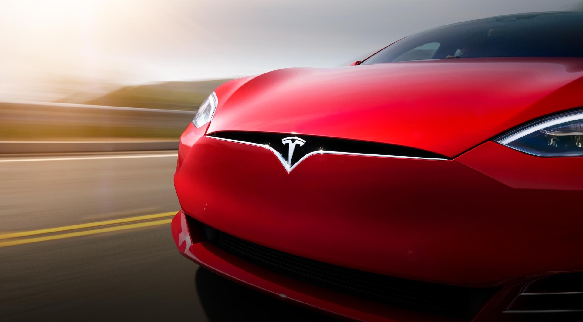 Red Tesla Model S driving on road HD Wallpaper