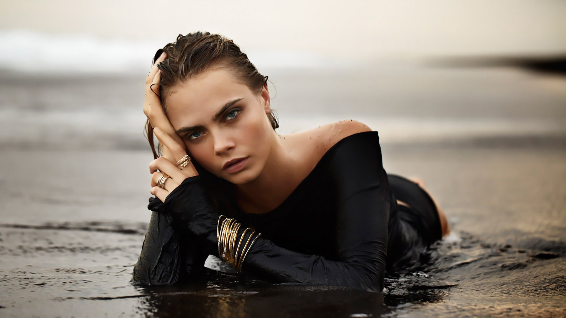 Cara Delevingne lying in shallow water HD Wallpaper