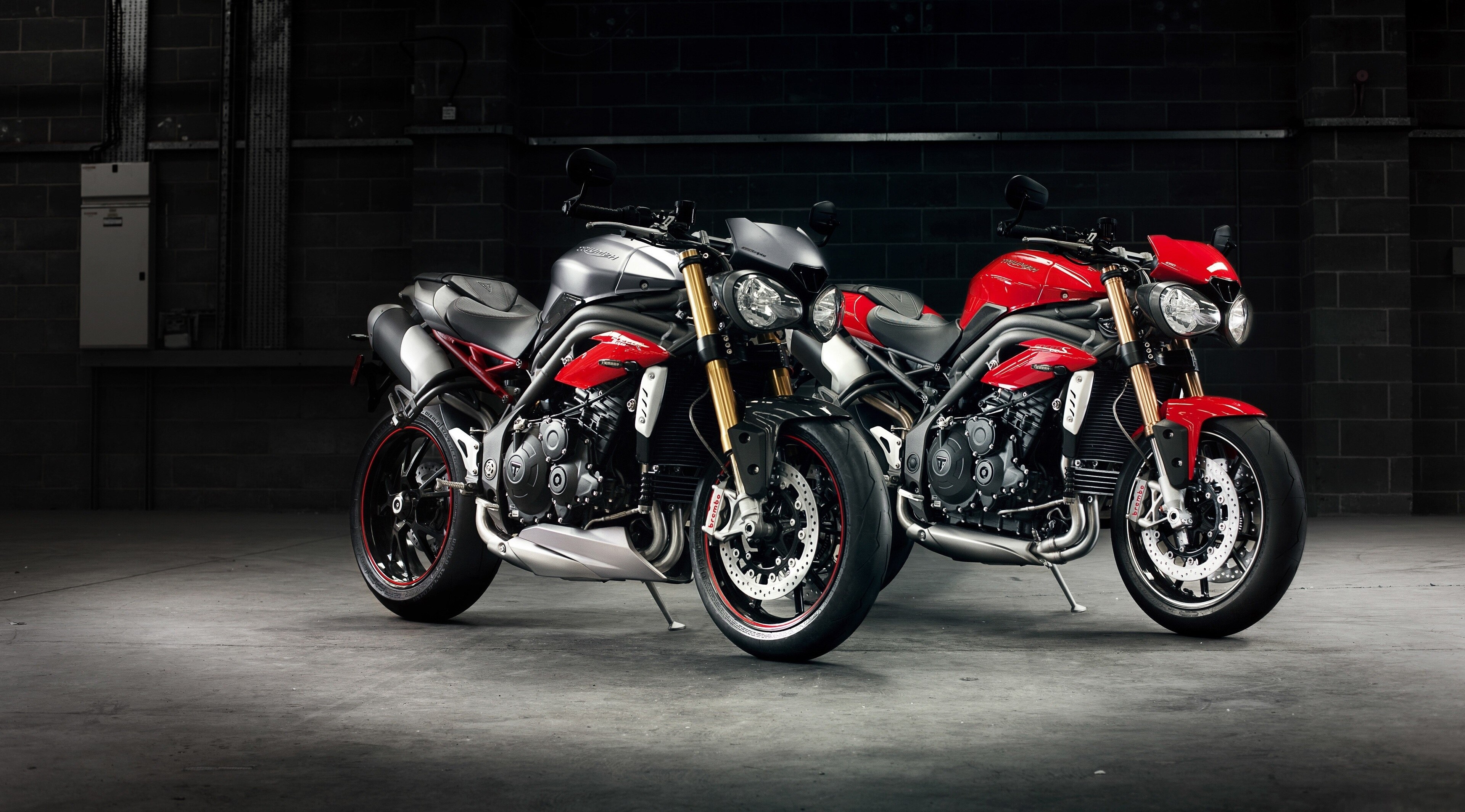 Two Triumph Speed Triple R motorcycles in a garage HD Wallpaper