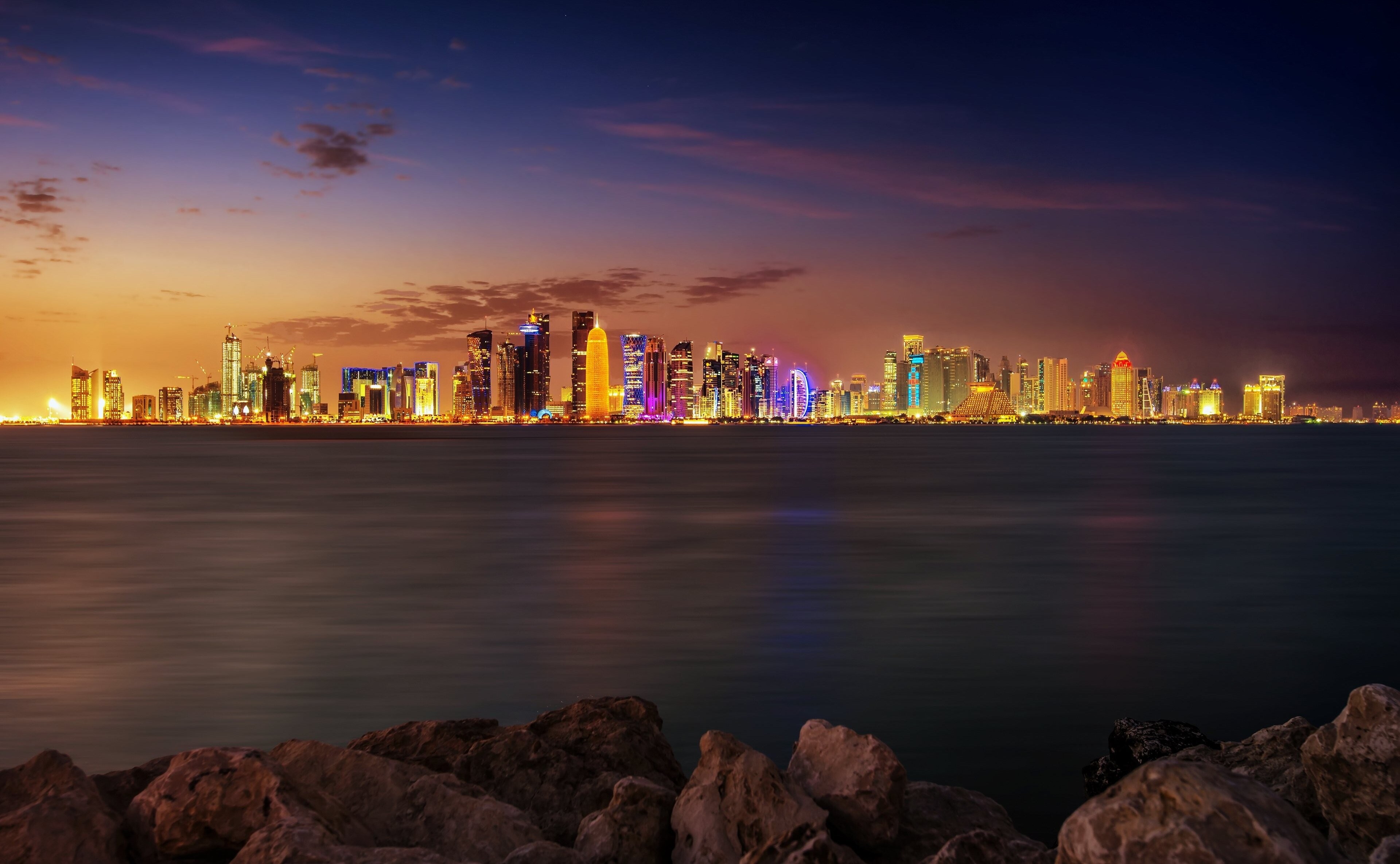 Doha skyline at dusk with ocean in foreground HD Wallpaper