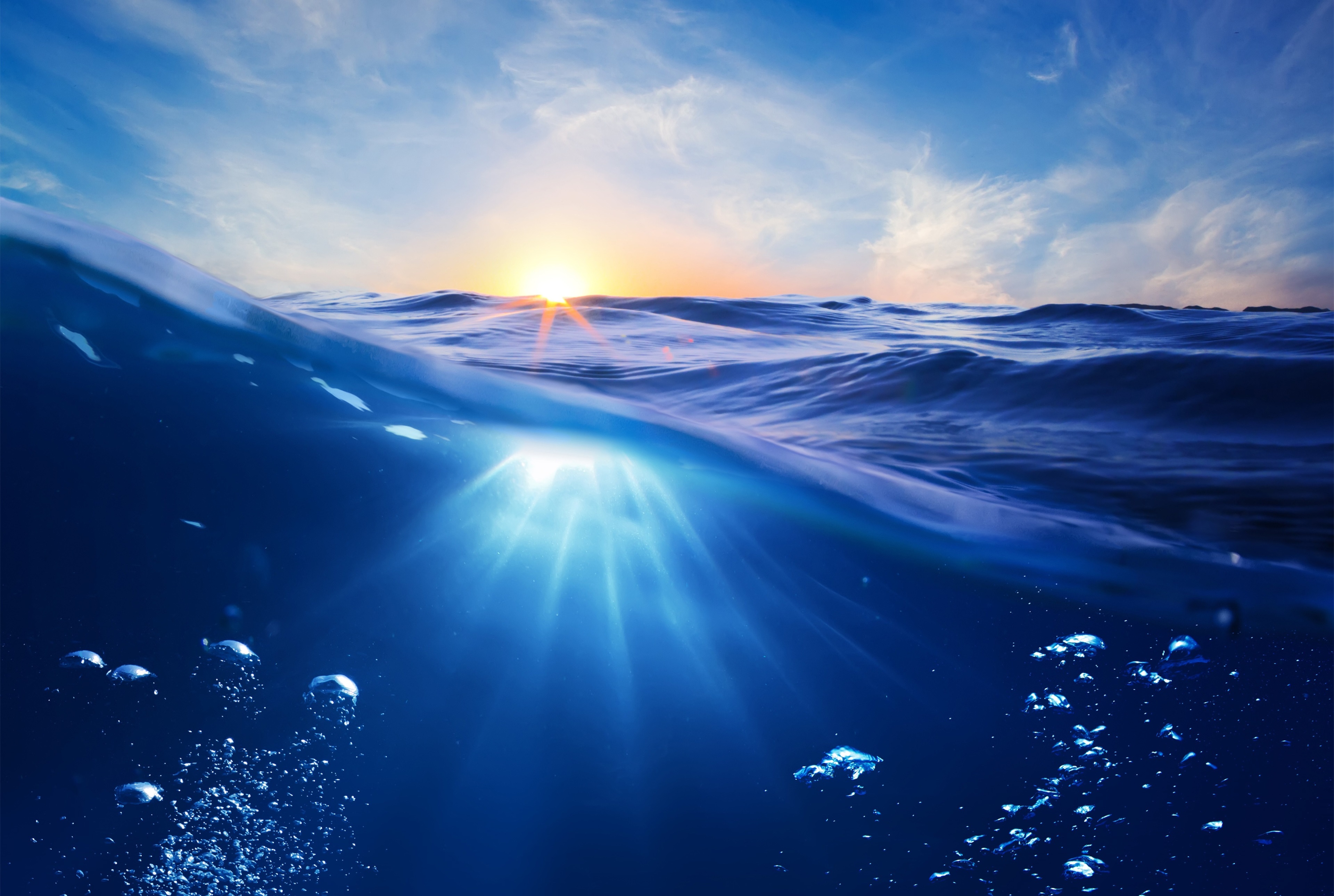 Ocean surface and underwater view at sunset 4K HD Wallpaper
