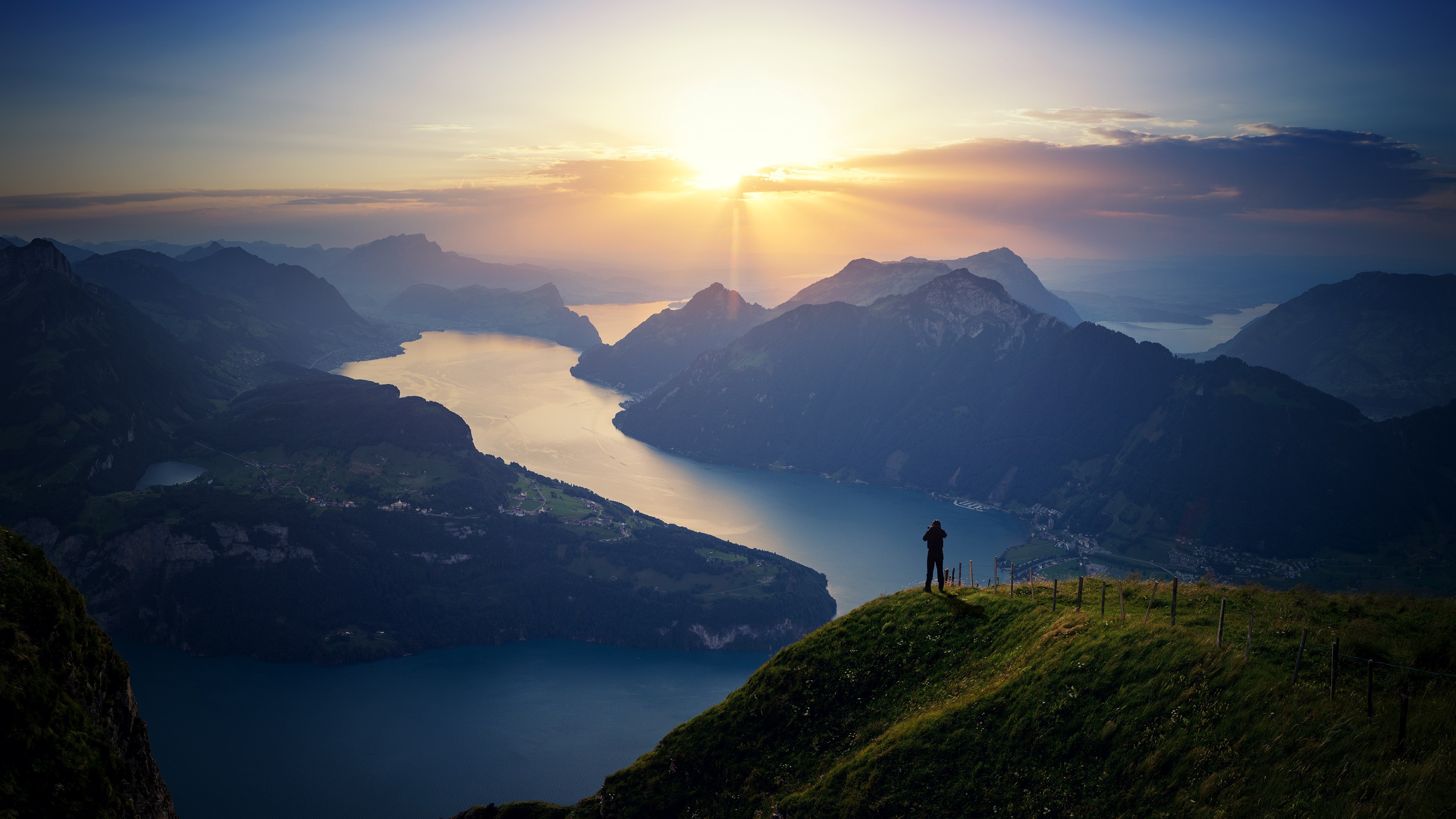 Sunrise over mountains and lake with a person HD Wallpaper