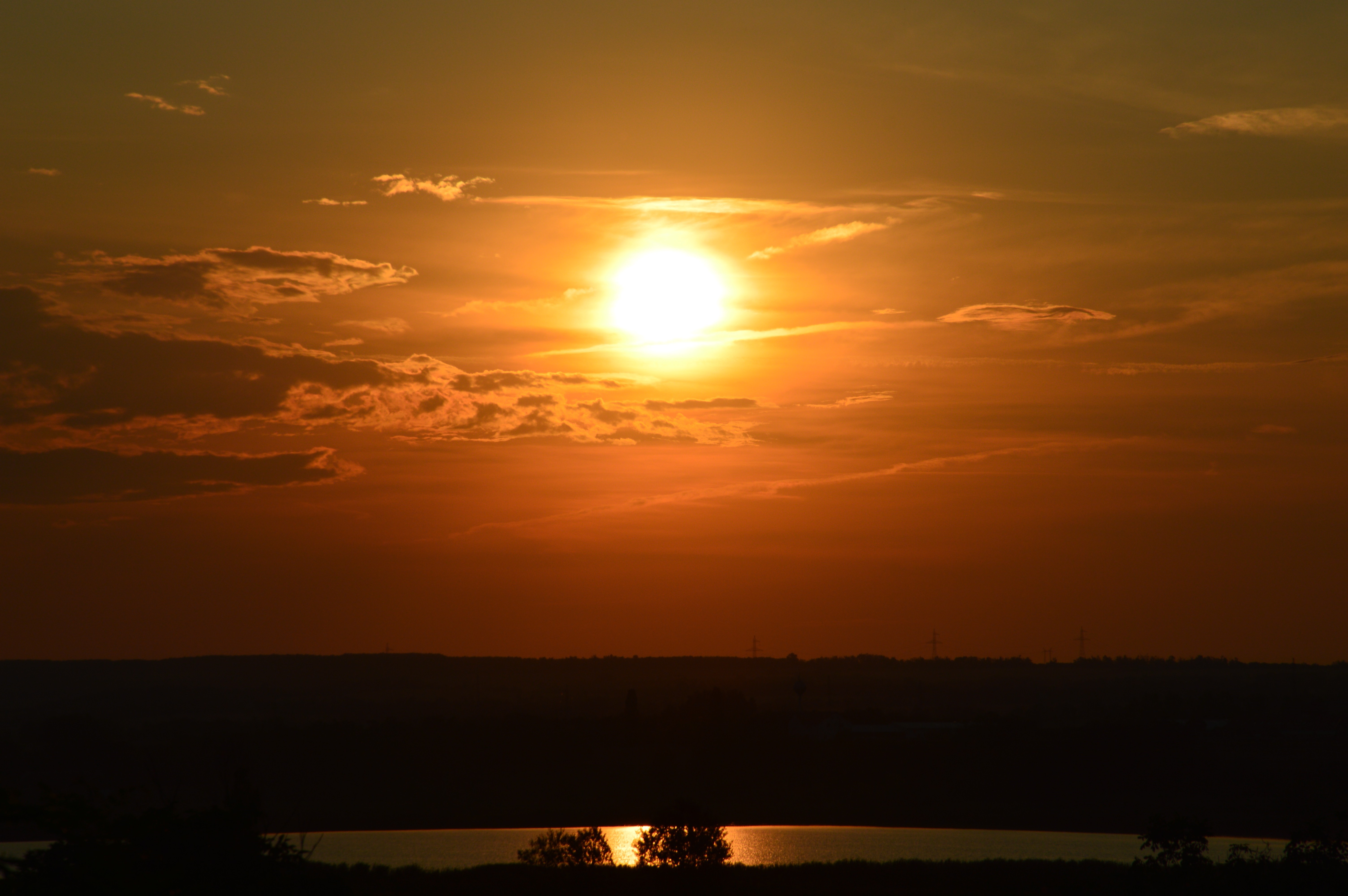 Sunset over a landscape with a lake HD Wallpaper