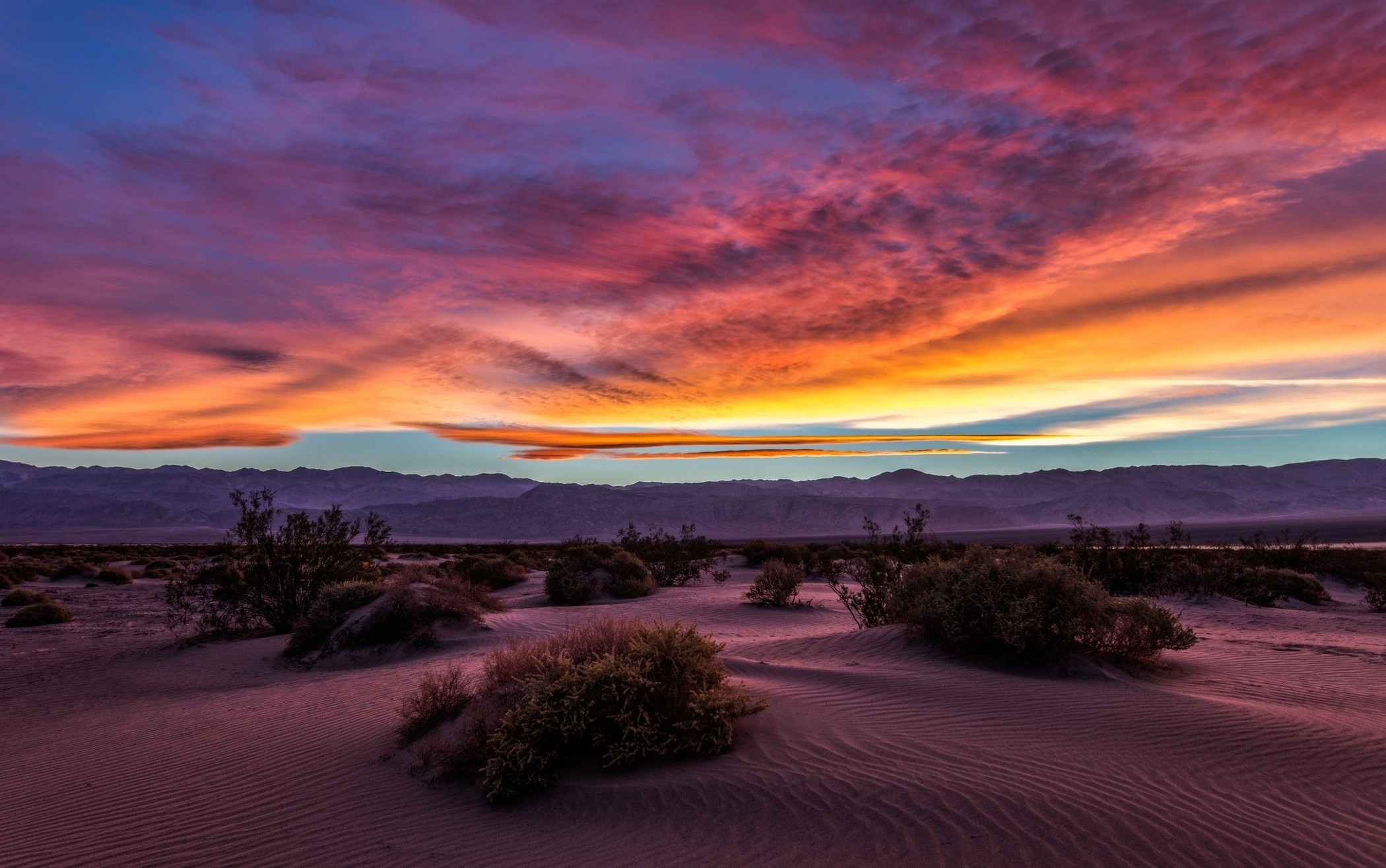 Desert sunset over sand dunes and mountains HD Wallpaper