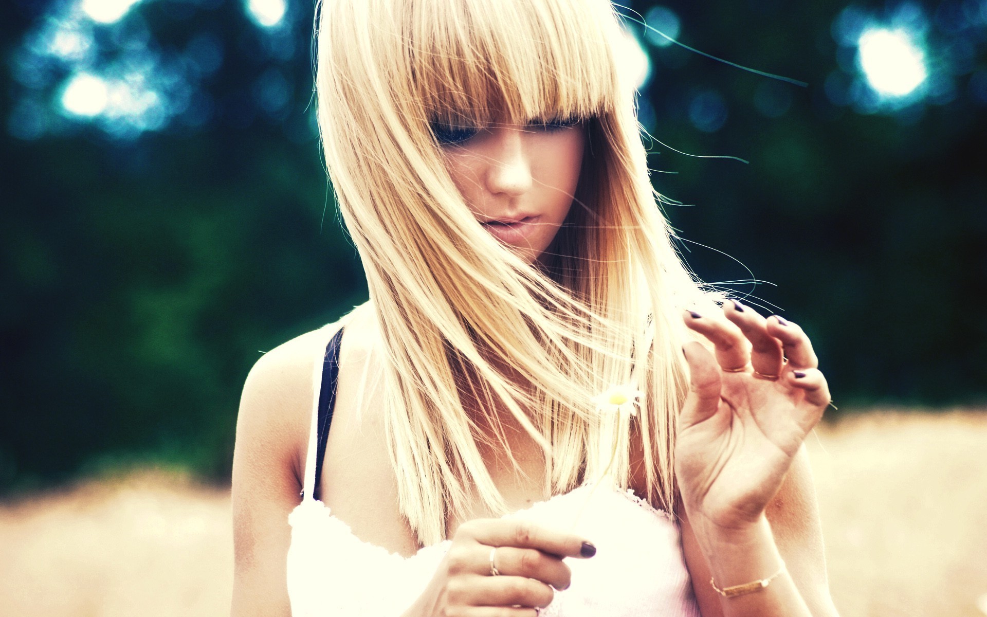 Woman with blonde hair holding a flower HD Wallpaper