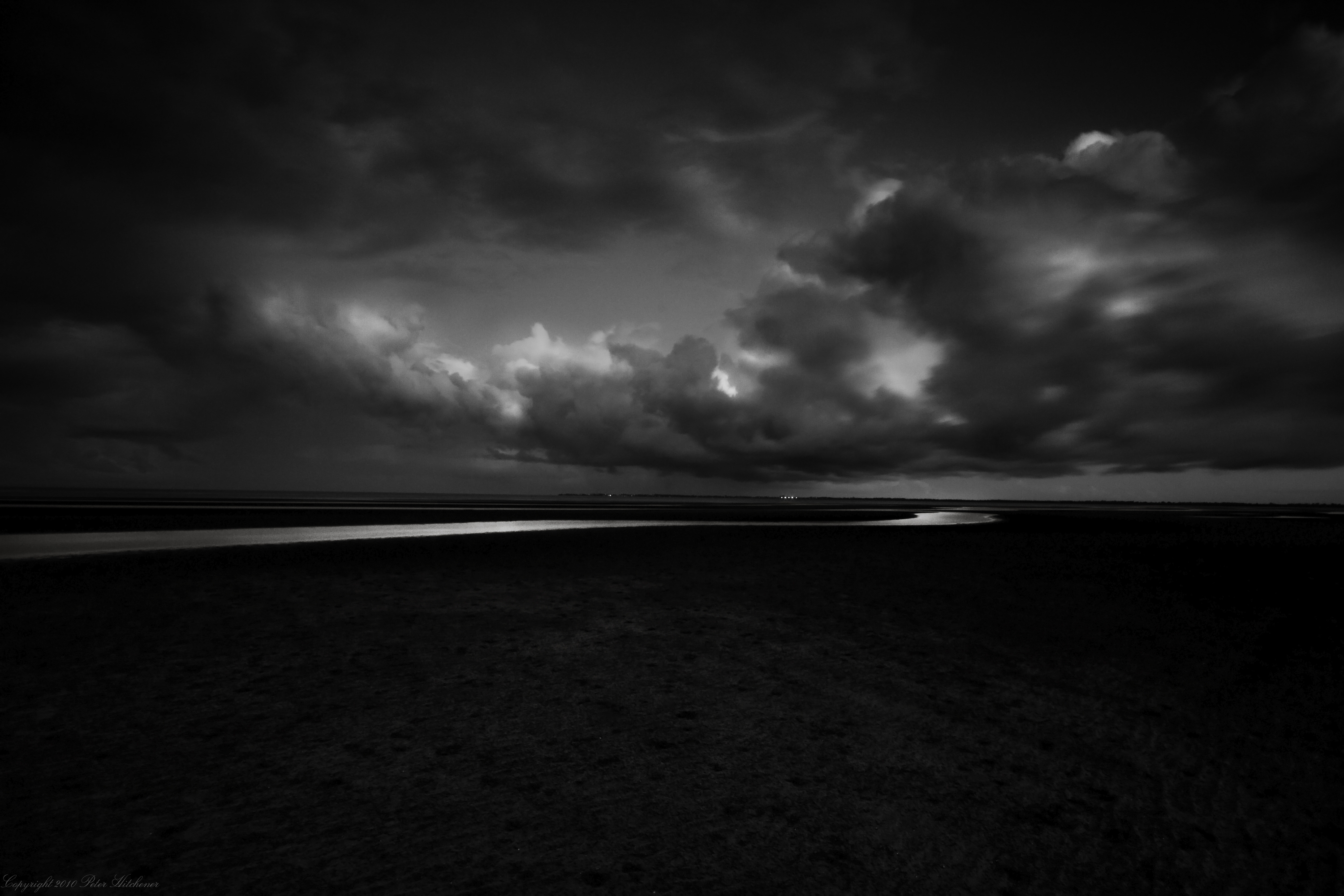 Monochrome landscape with dark clouds and a river HD Wallpaper