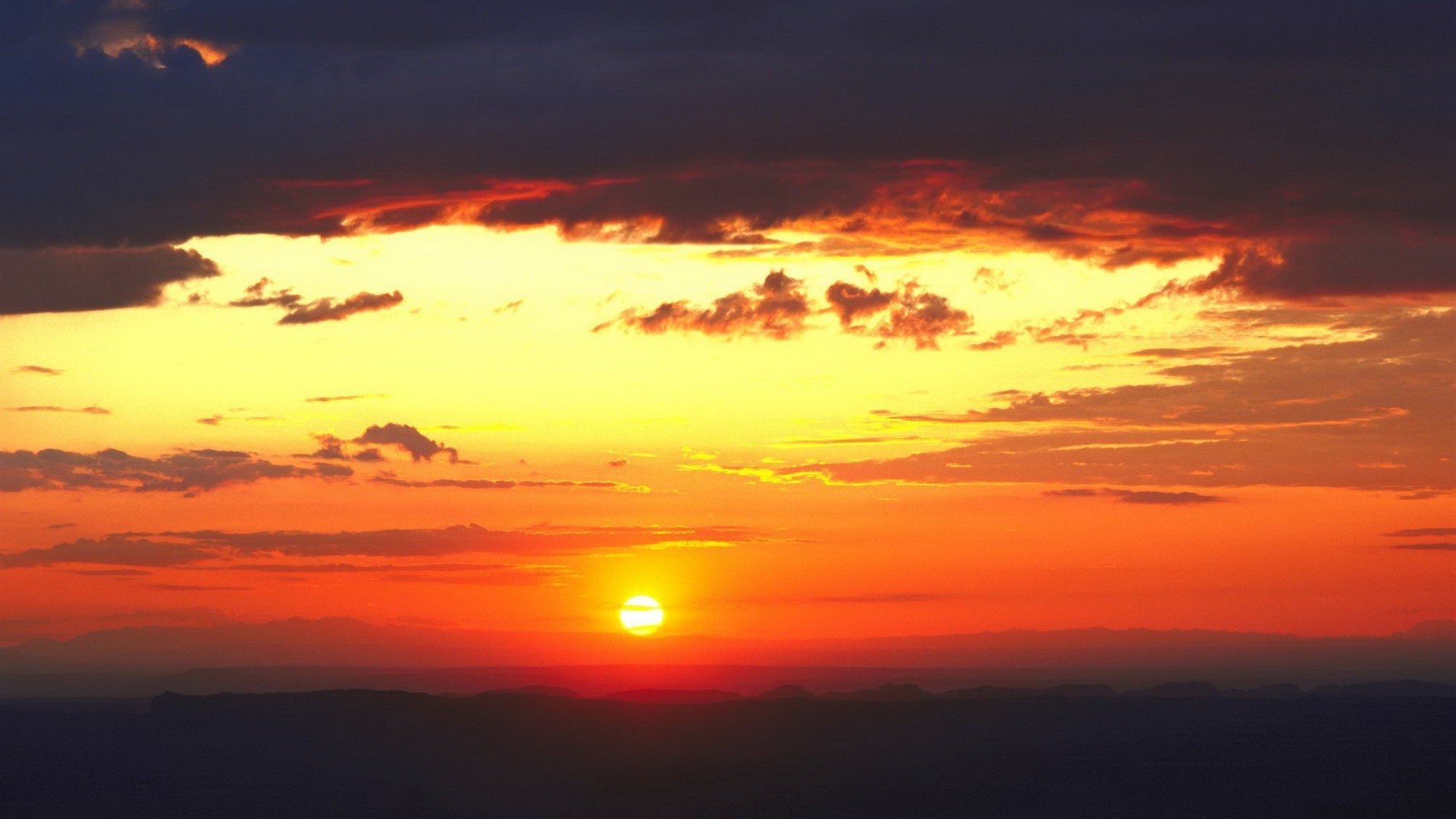 Sunset over mountains with dramatic clouds HD Wallpaper