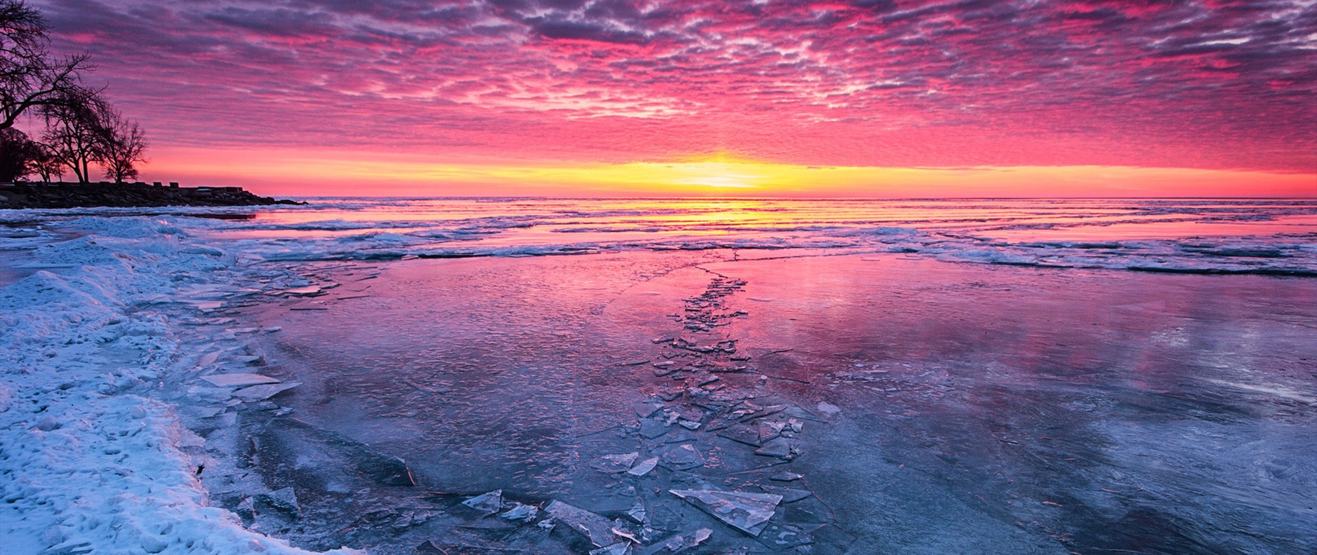 Frozen lake at sunrise with pink and yellow sky HD Wallpaper