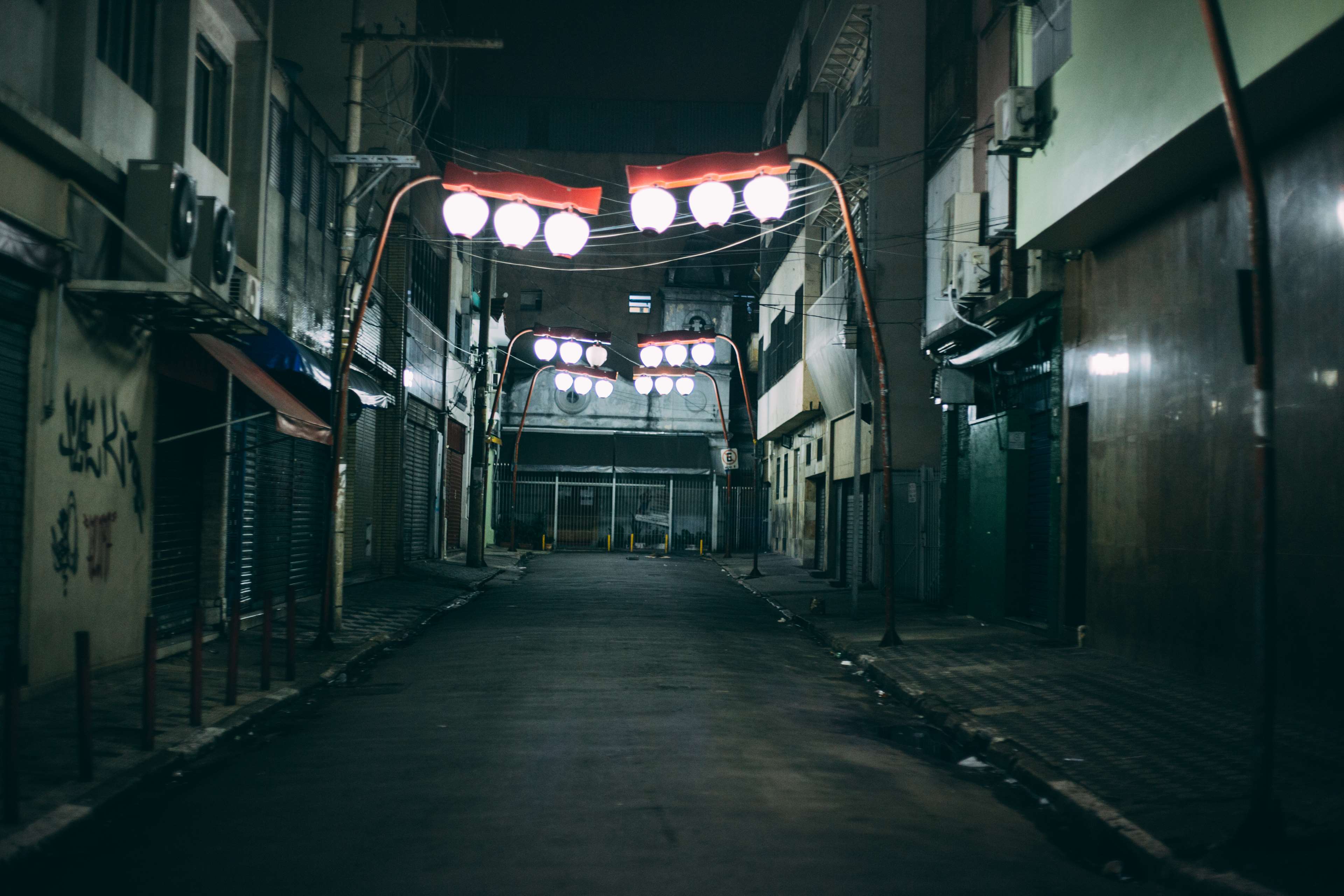 Empty city alley at night with street lights HD Wallpaper