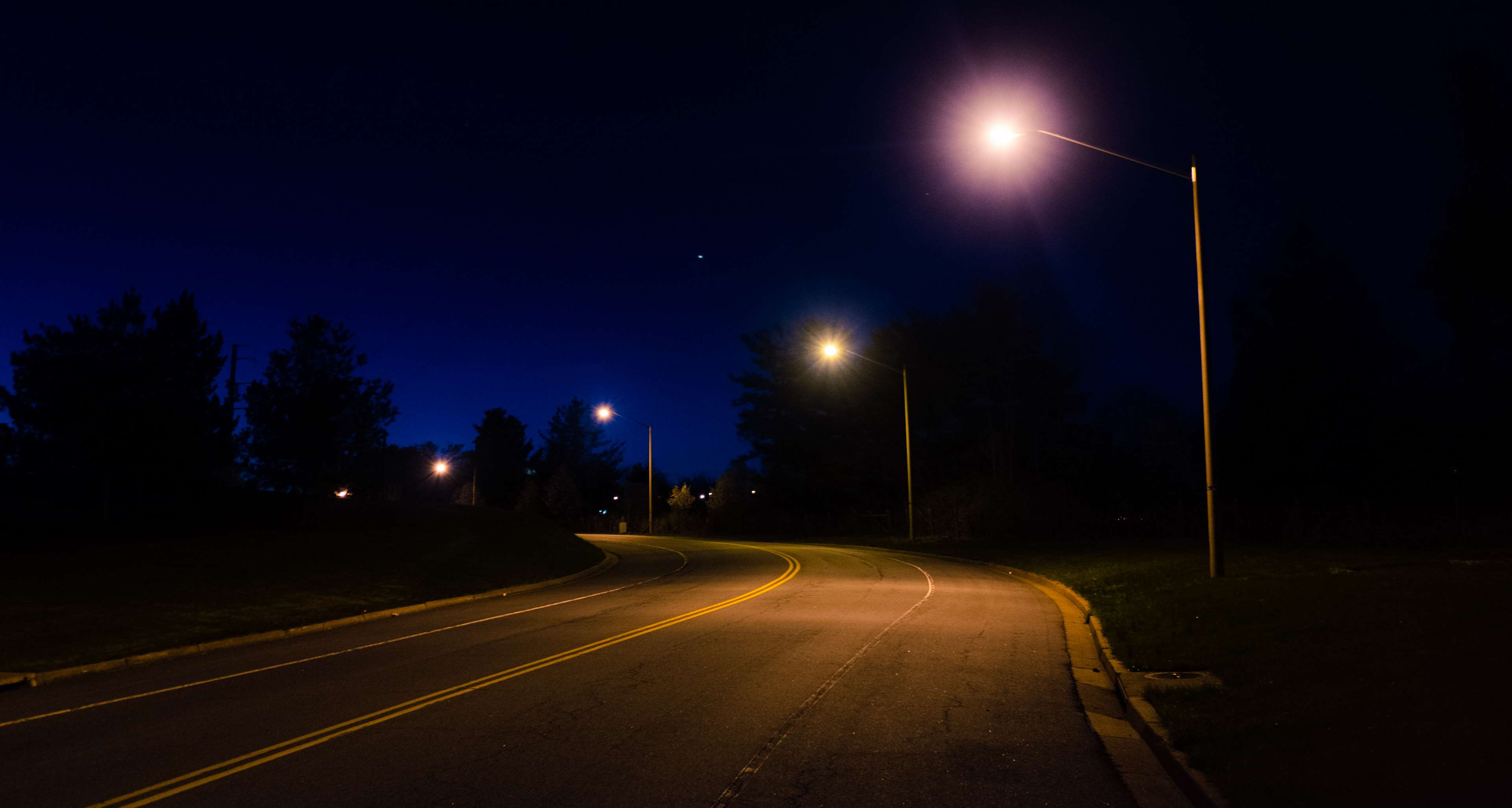 Road at night with street lights HD Wallpaper