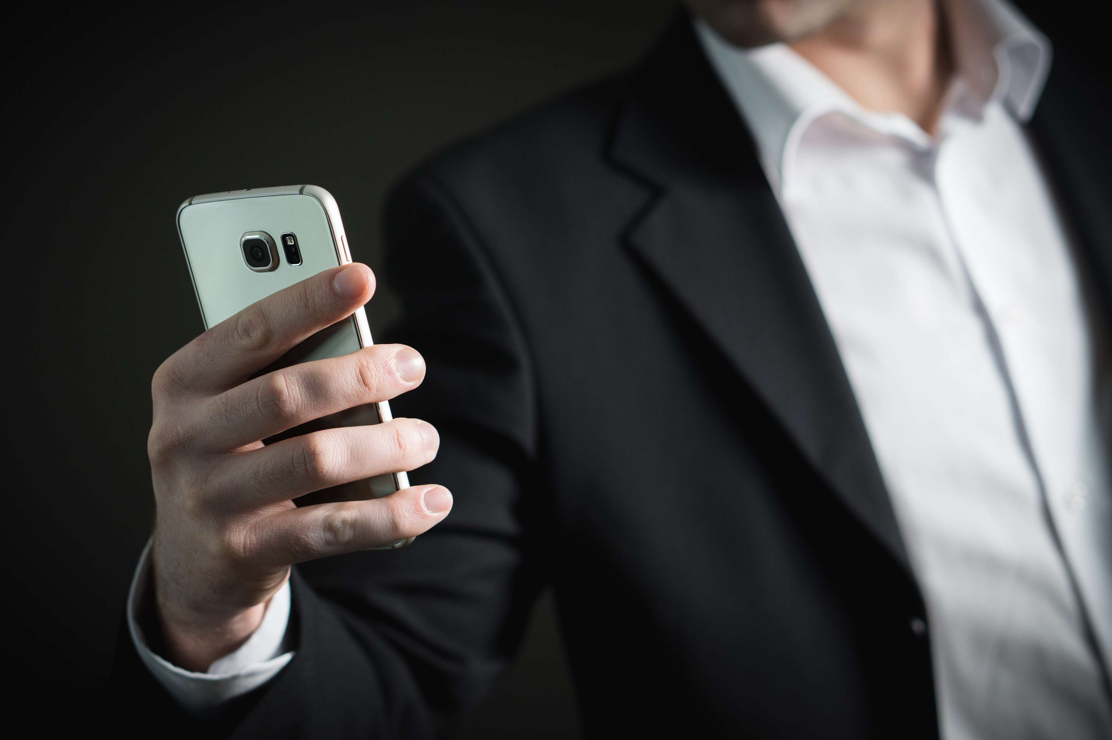 Man in Suit Holding a Smartphone HD Wallpaper