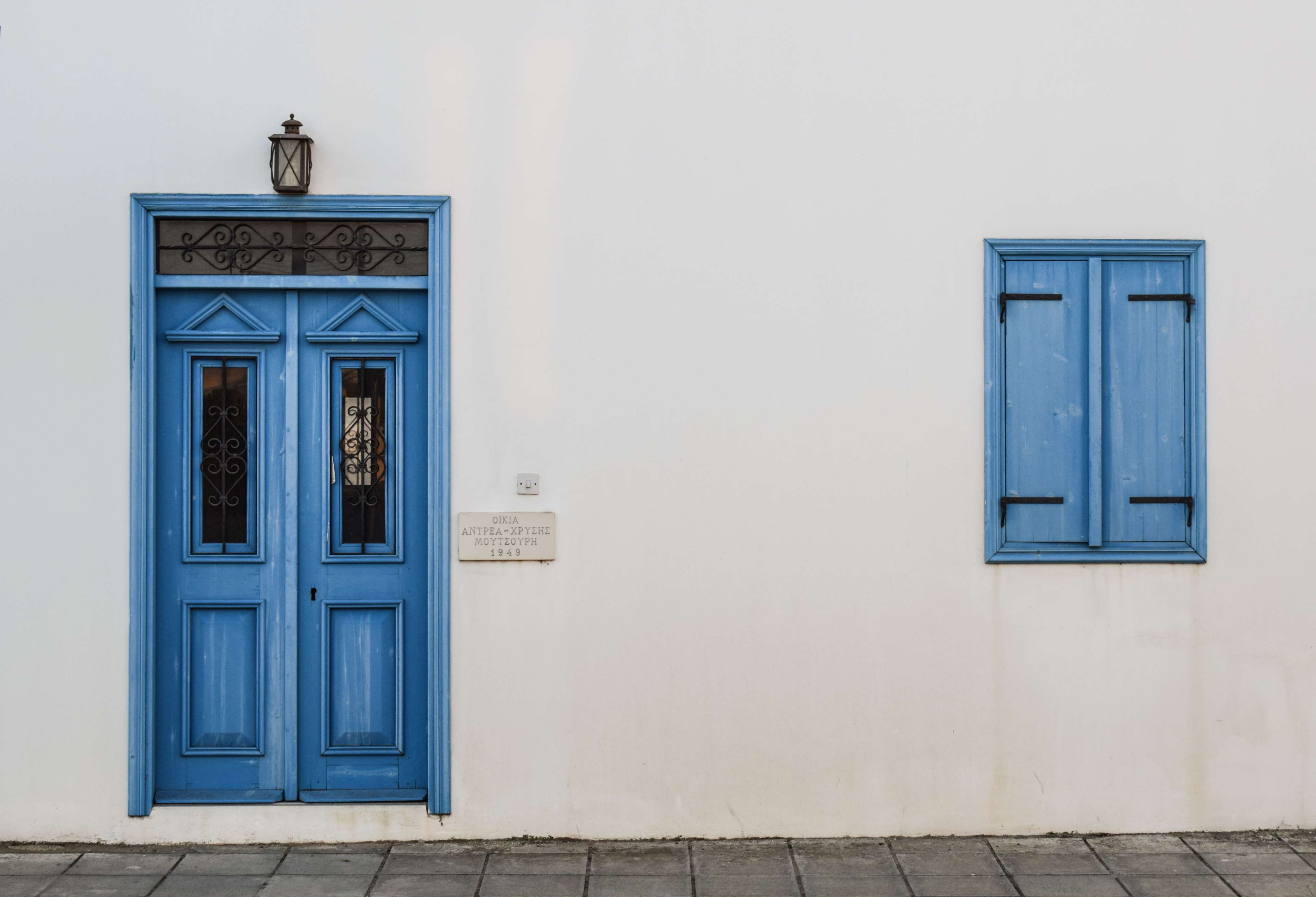 Traditional blue door and window on white wall in Cyprus 4K HD Wallpaper