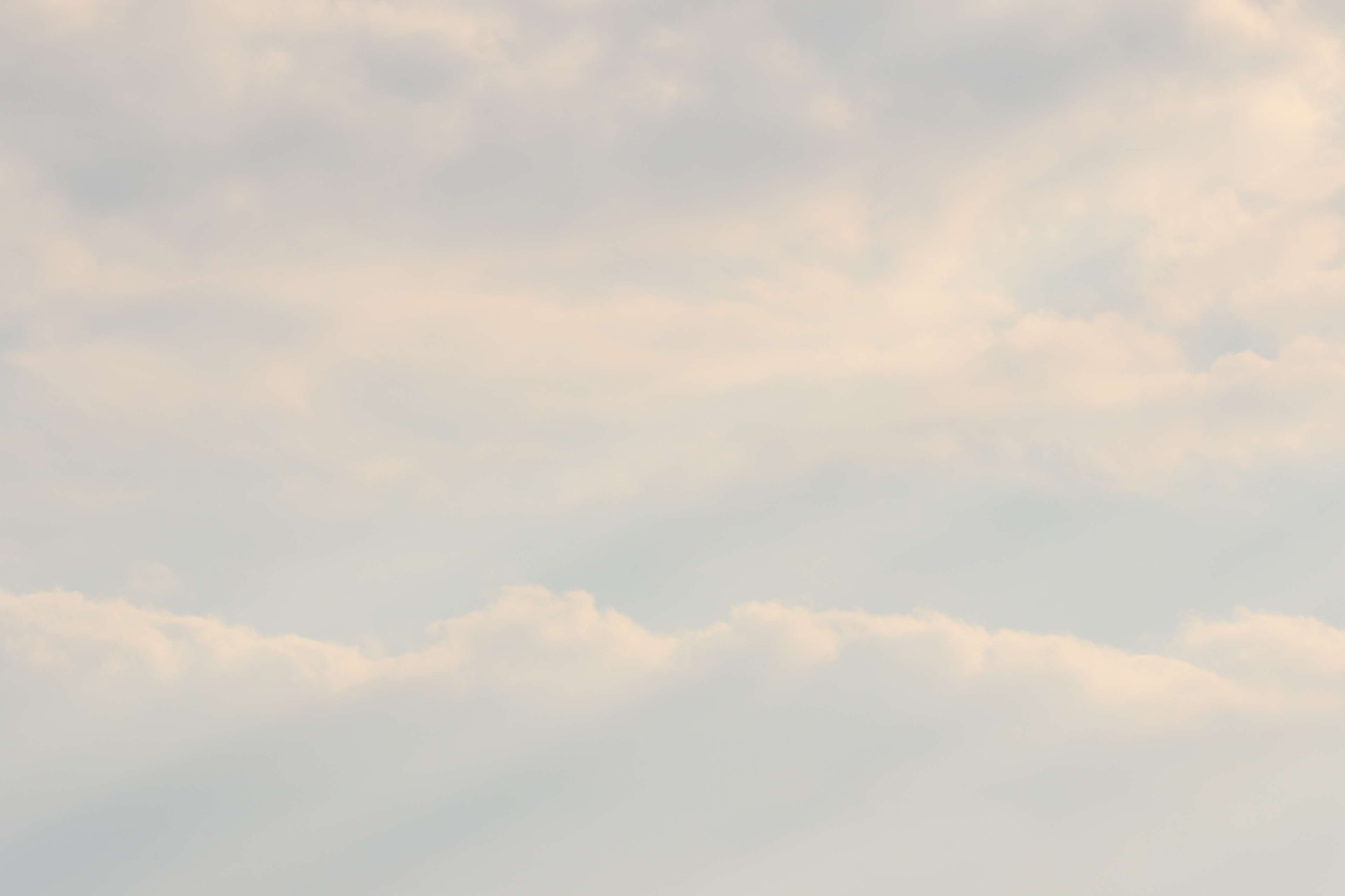 Soft clouds in a pale blue sky 4K HD Wallpaper