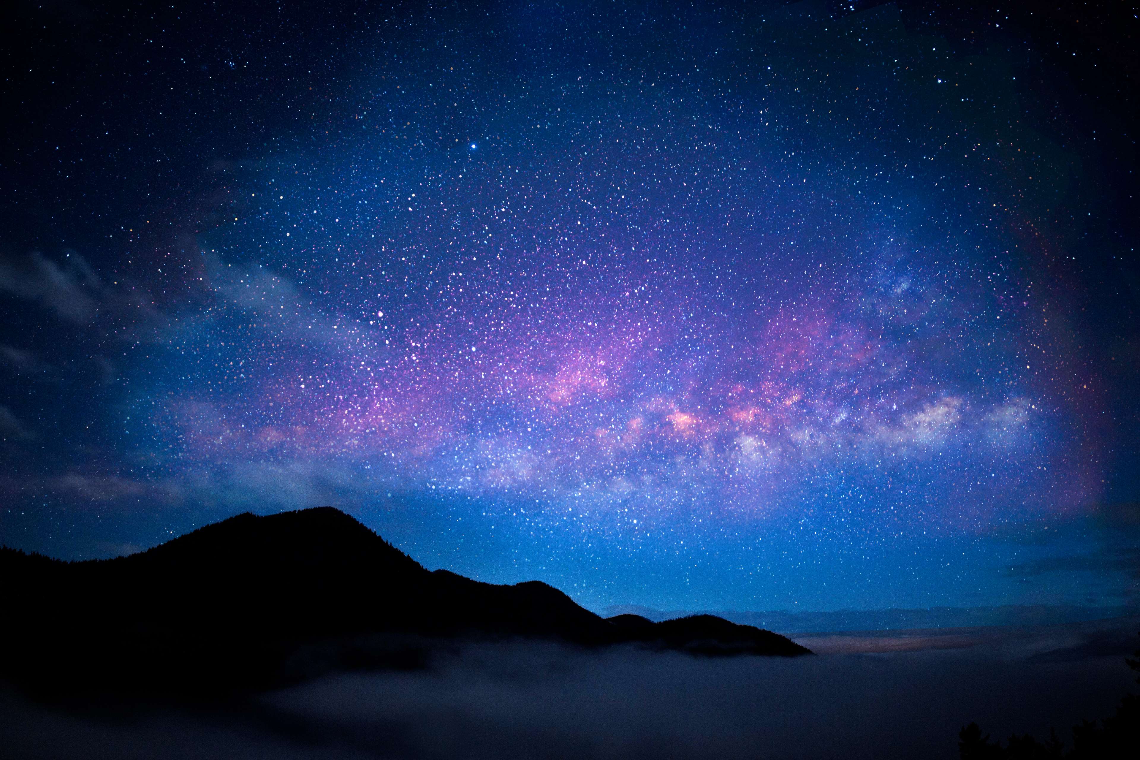 Starry night sky over foggy mountains 4K HD Wallpaper