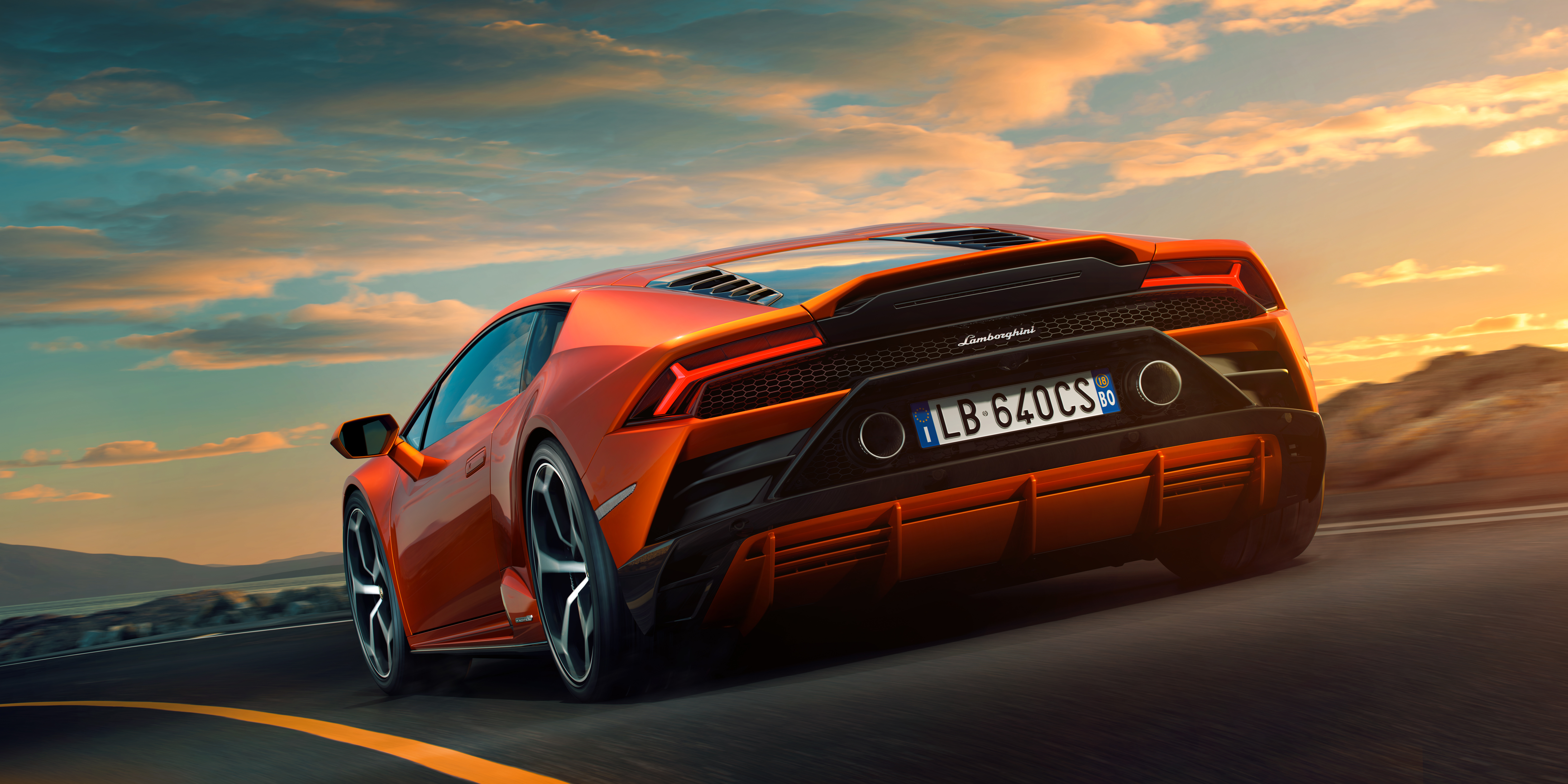 Orange Lamborghini Huracan Evo on a road HD Wallpaper