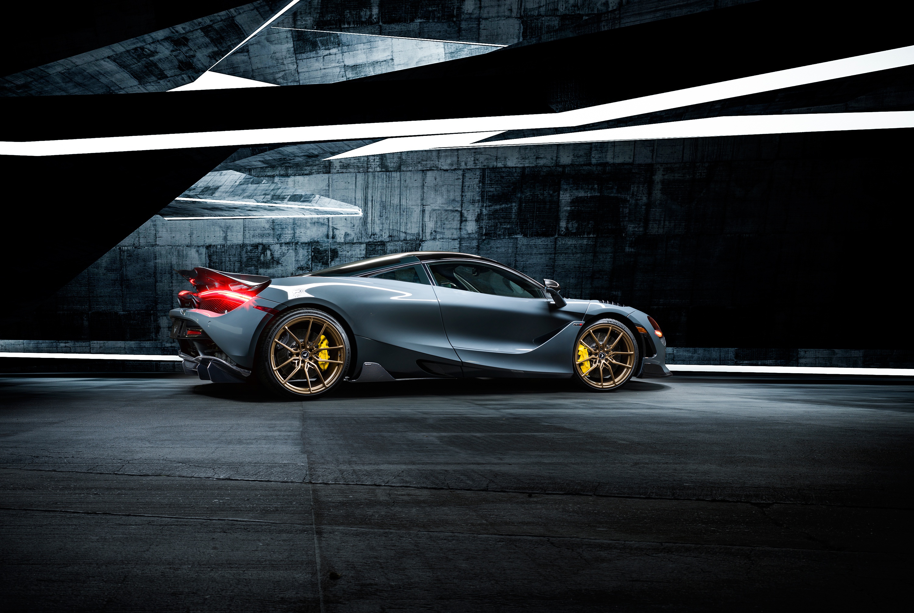 McLaren 720S supercar in a dark, modern architectural space HD Wallpaper