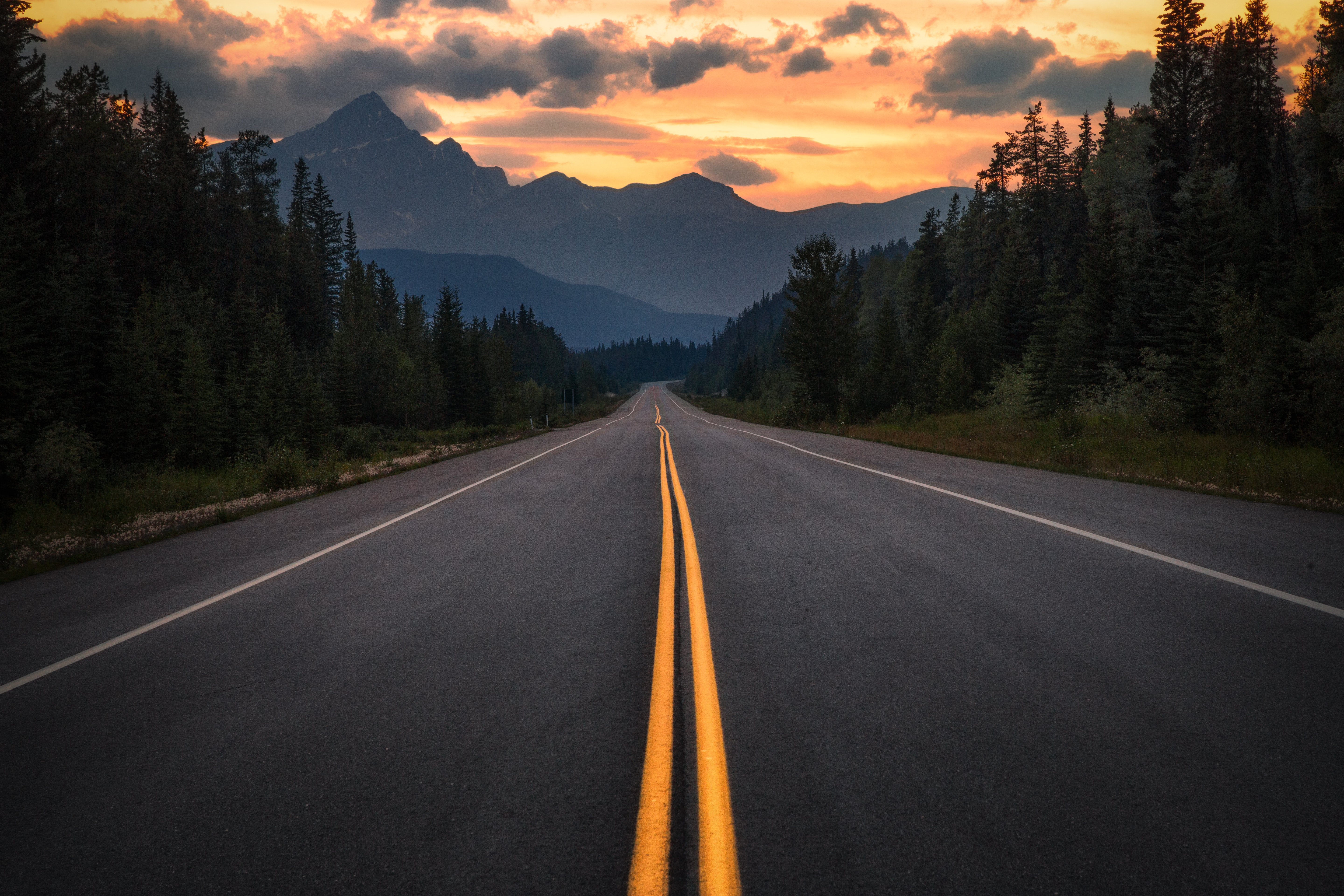 Road through mountains at sunset HD Wallpaper