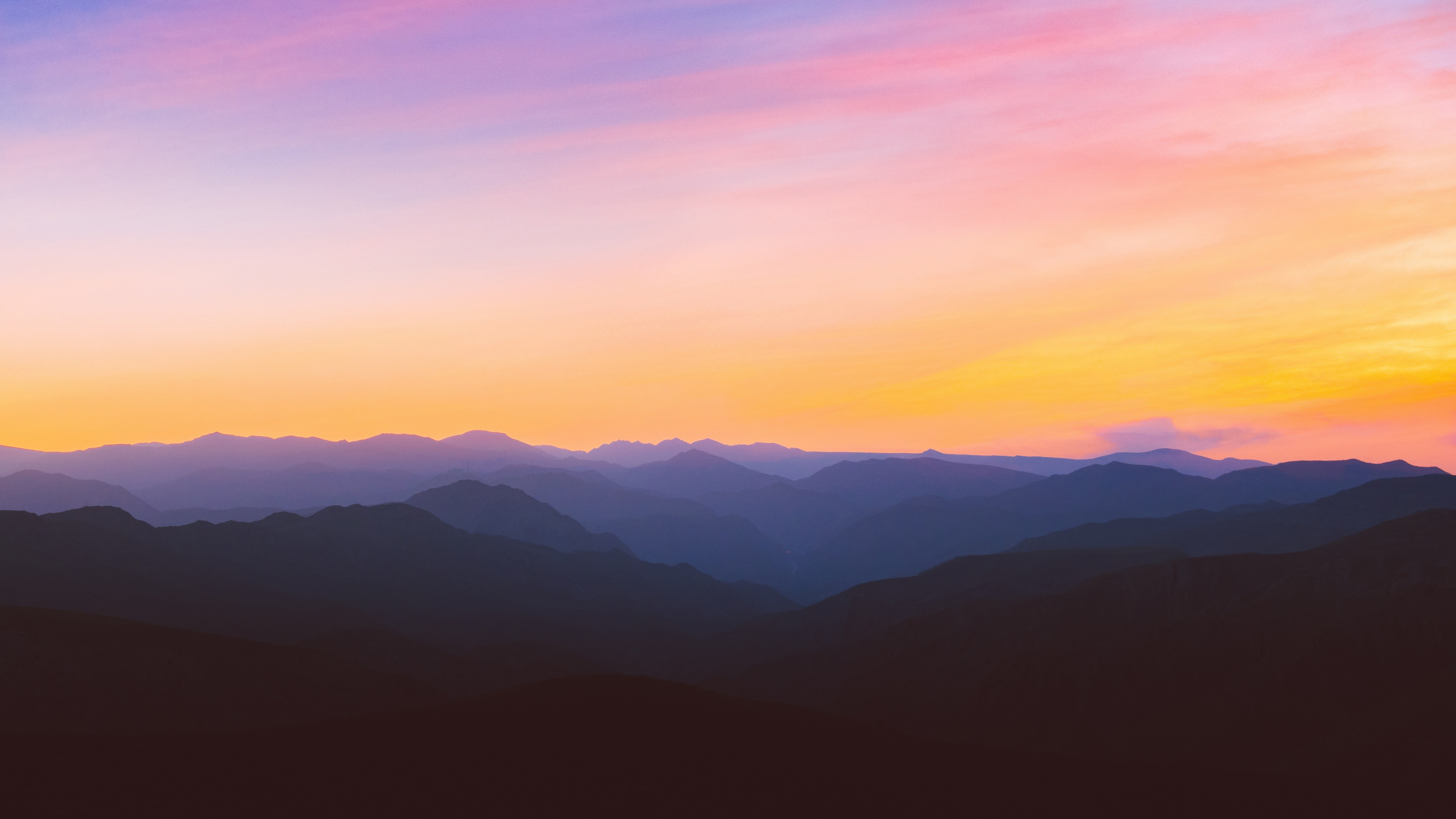 Mountain range at sunset with colorful sky HD Wallpaper