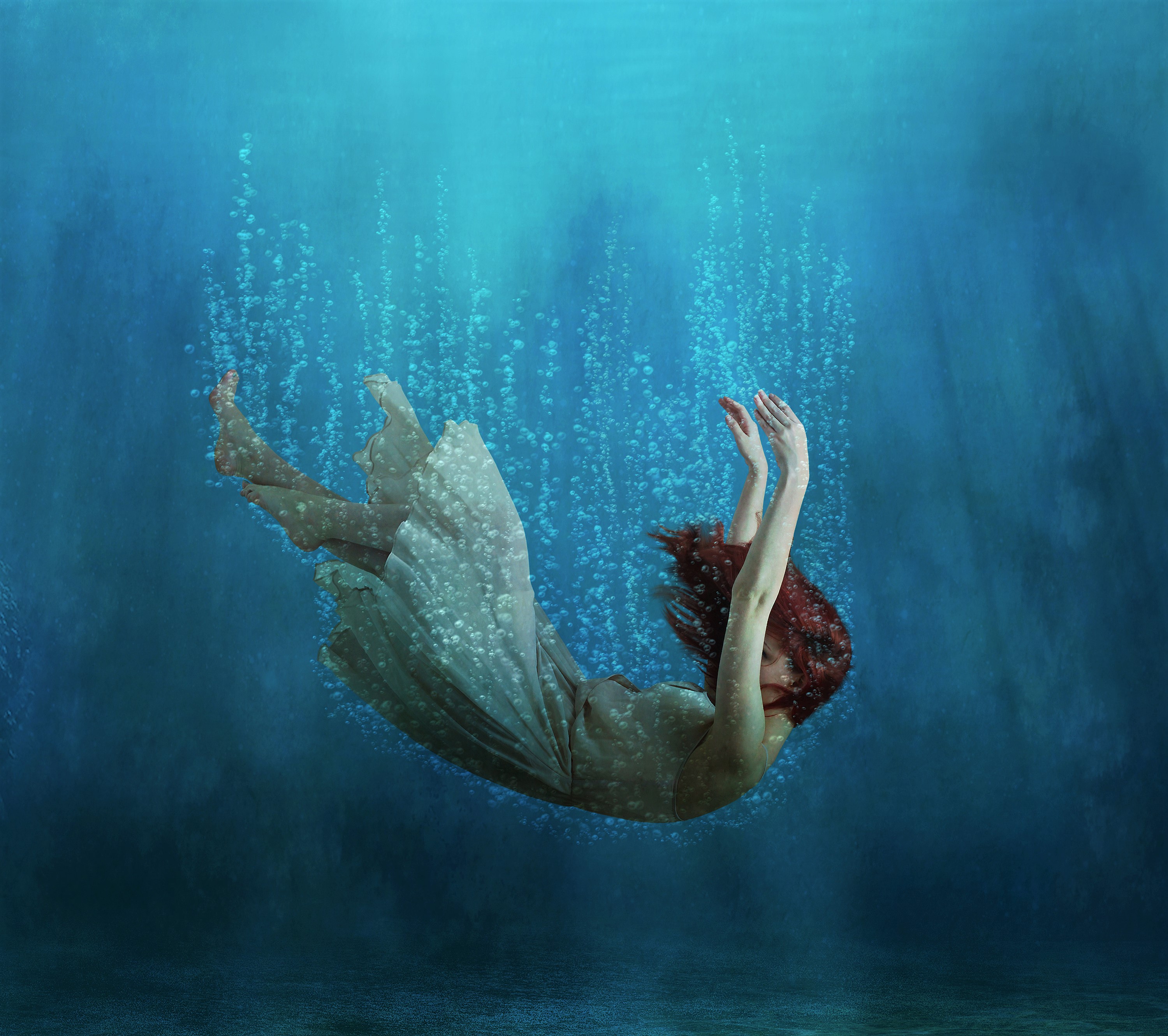 Woman with Red Hair Falling Underwater Surrounded by Bubbles HD Wallpaper