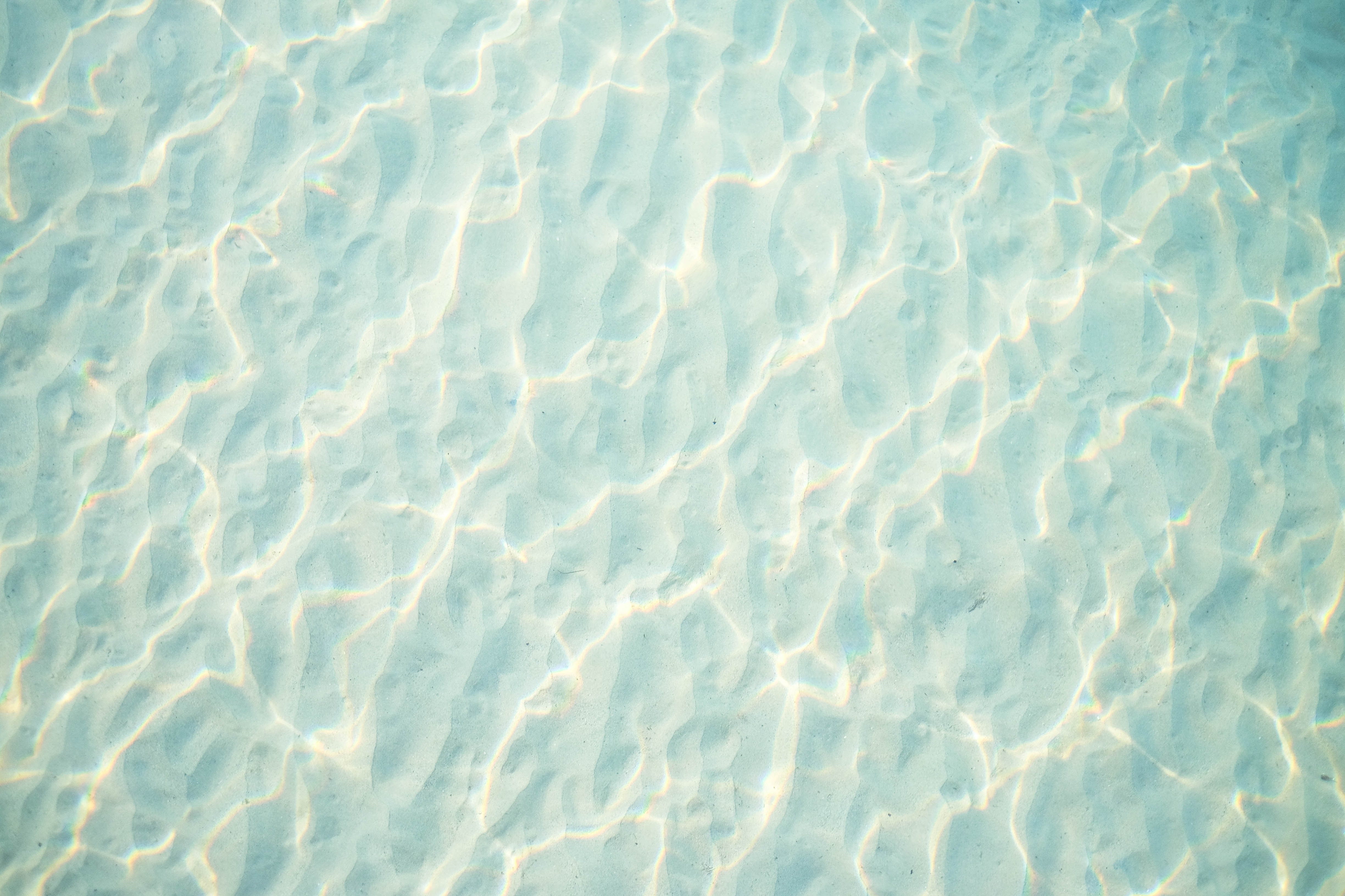 Underwater sand ripples with light patterns HD Wallpaper