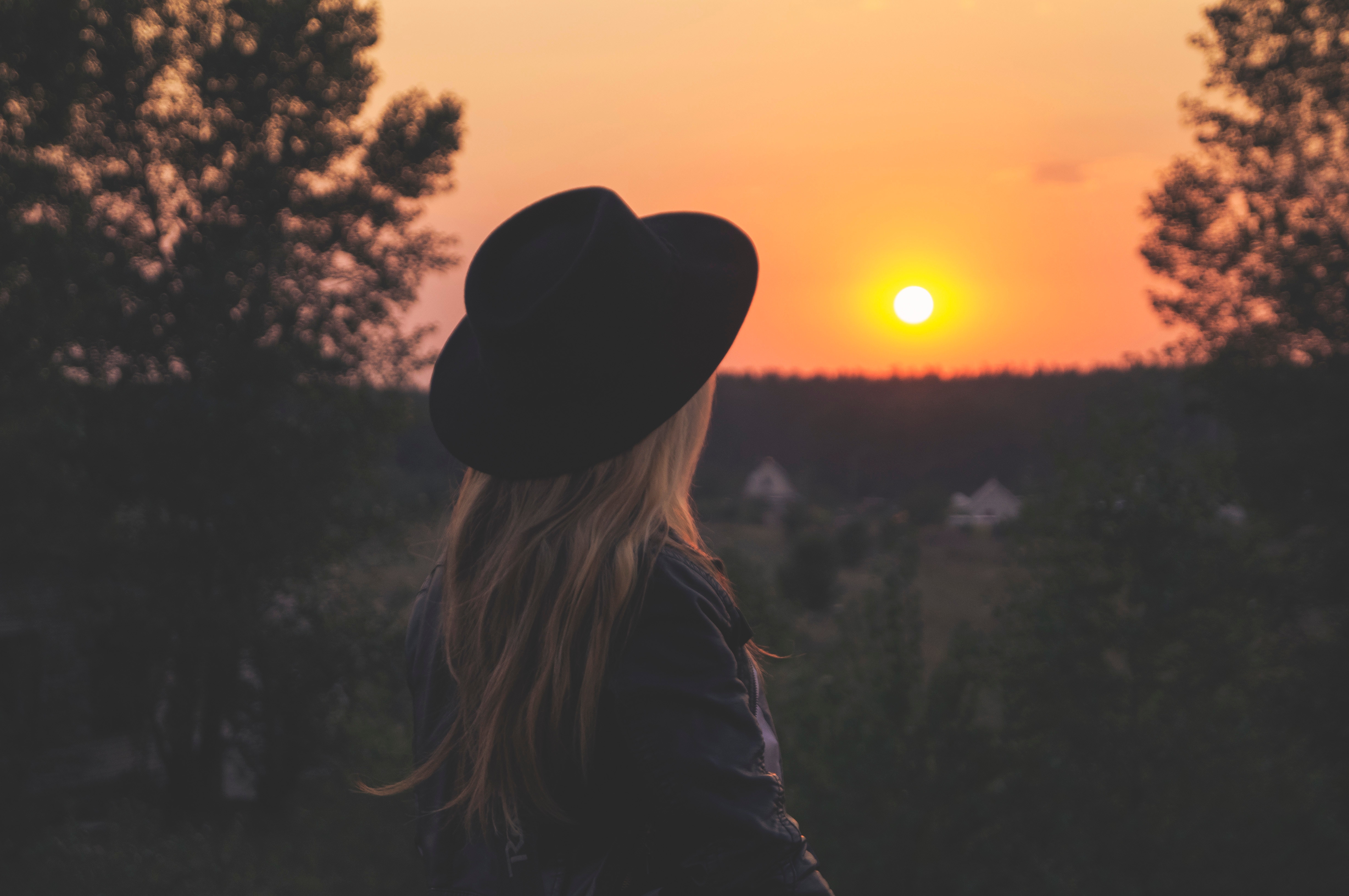 Woman in Fedora Watching Sunset Over Rubizhne HD Wallpaper