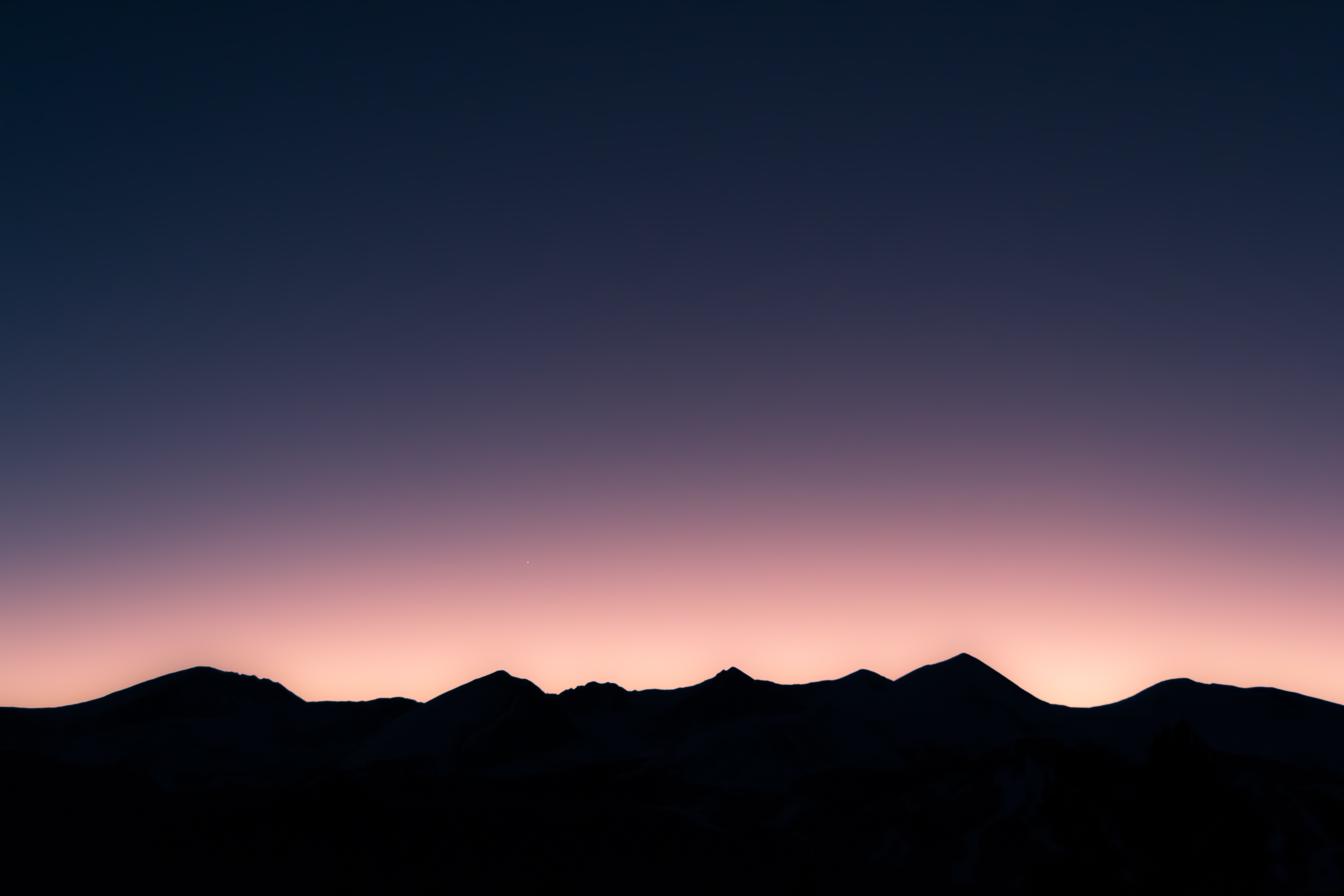 Silhouette of mountains against a twilight sky HD Wallpaper