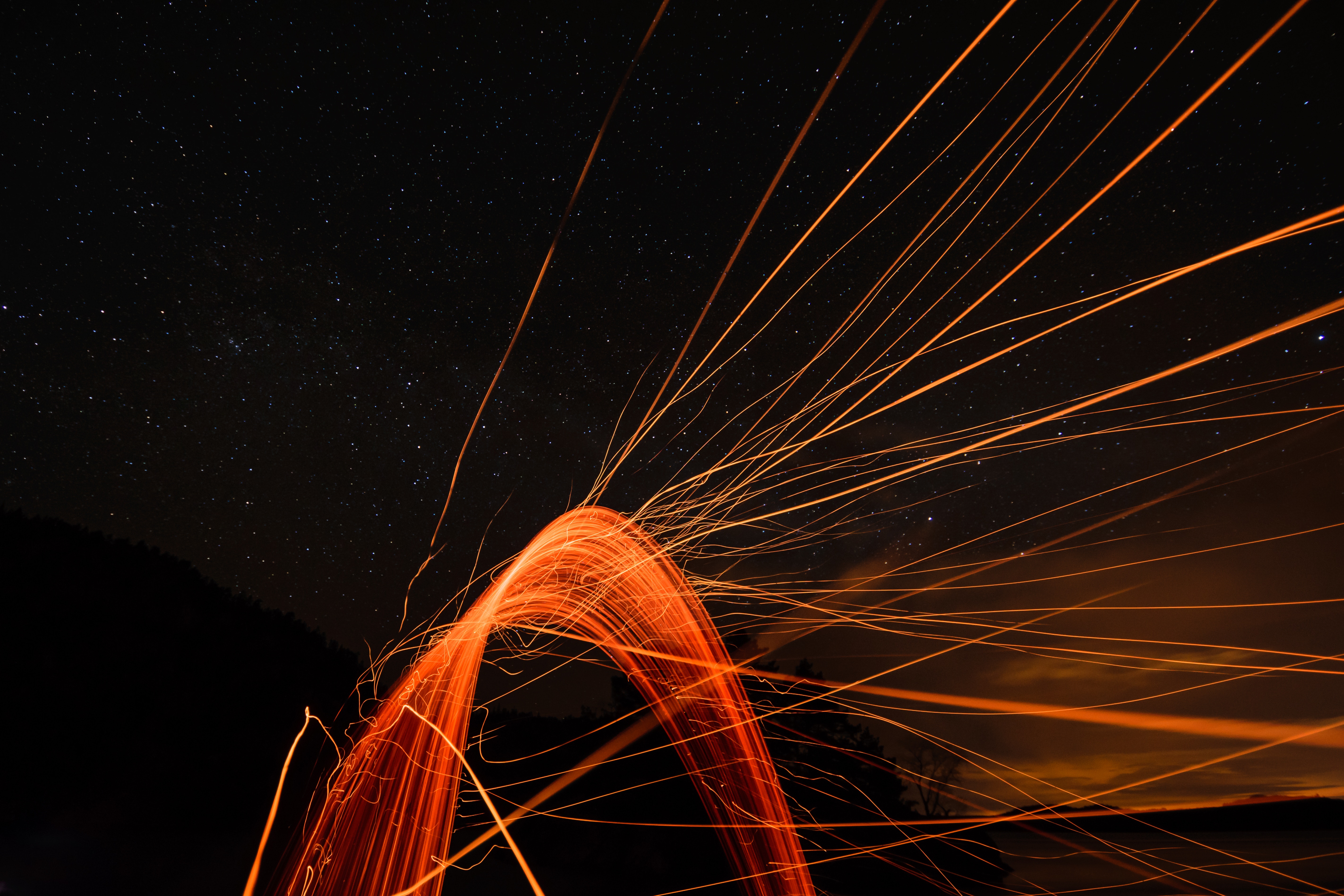 Light painting with sparks under a starry sky HD Wallpaper