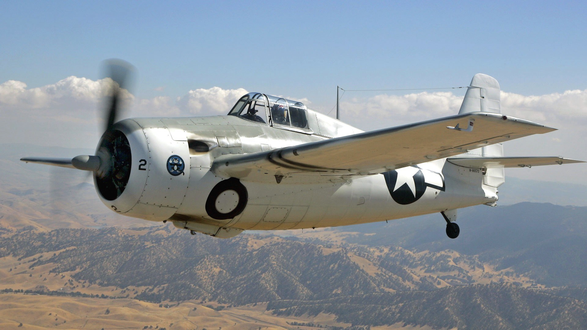 Grumman F4F Wildcat in flight over mountains HD Wallpaper