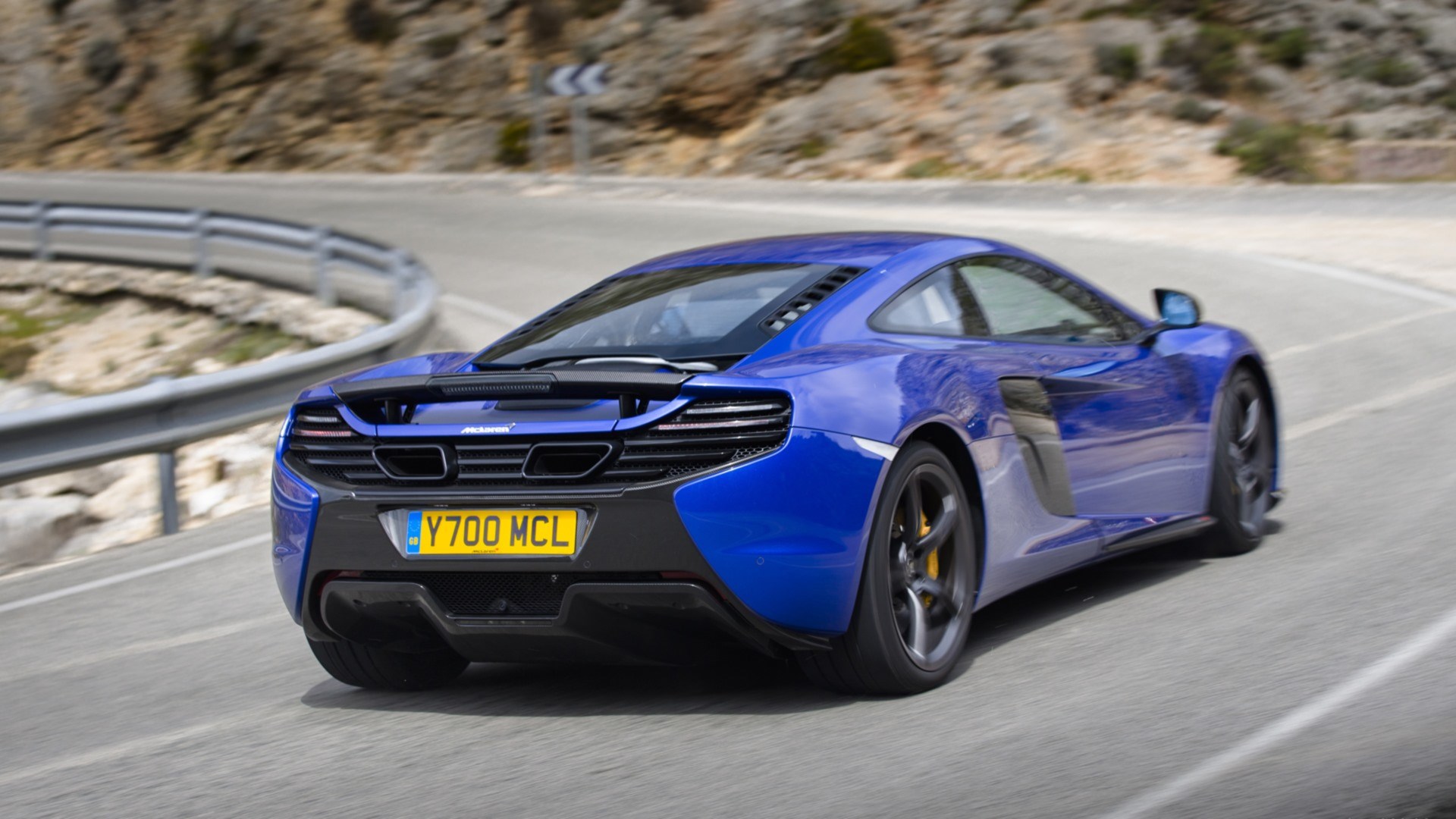Blue McLaren 650S driving on a winding road HD Wallpaper