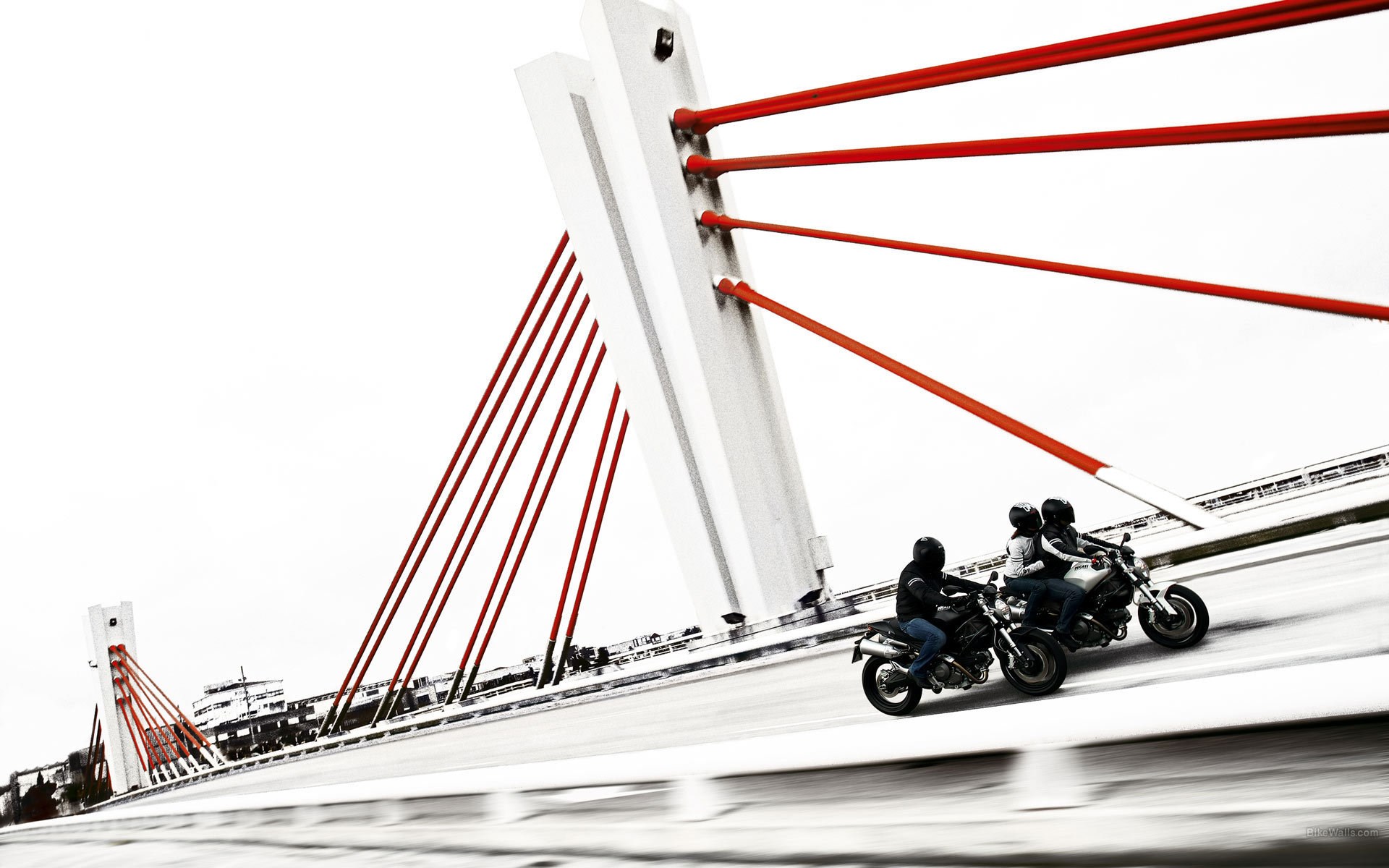 Motorcyclists on a bridge with red cables HD Wallpaper
