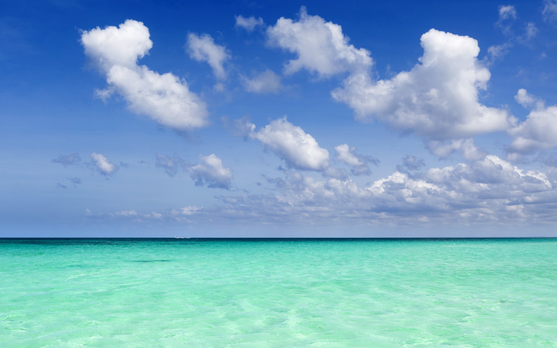 Turquoise ocean under a blue sky with clouds HD Wallpaper